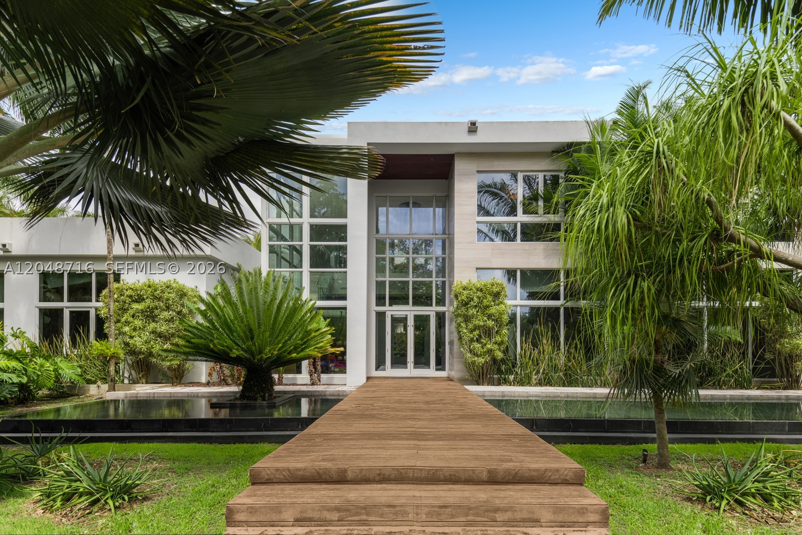 When Only the Best Will Do. Inspired by the beauty and sophistication of Bali and infused with a refined modern aesthetic, this extraordinary contemporary estate offers a resort-inspired lifestyle. Striking architecture, design, and seamless indoor-outdoor living come together to create a private sanctuary where every space has been thoughtfully curated.

The residence showcases expansive living areas, soaring ceilings, exquisite custom millwork, a movie theater, a chef's kitchen complemented by an oversized walk-in pantry, and a 3 car garage.

The luxurious primary suite serves as a true retreat, complete with private elevator access, an expansive sitting area overlooking the resort-style pool and summer kitchen. The primary bedroom suite offers a grand closet.

This remarkable residence offers an unparalleled lifestyle in a setting designed for you to make it your own.
