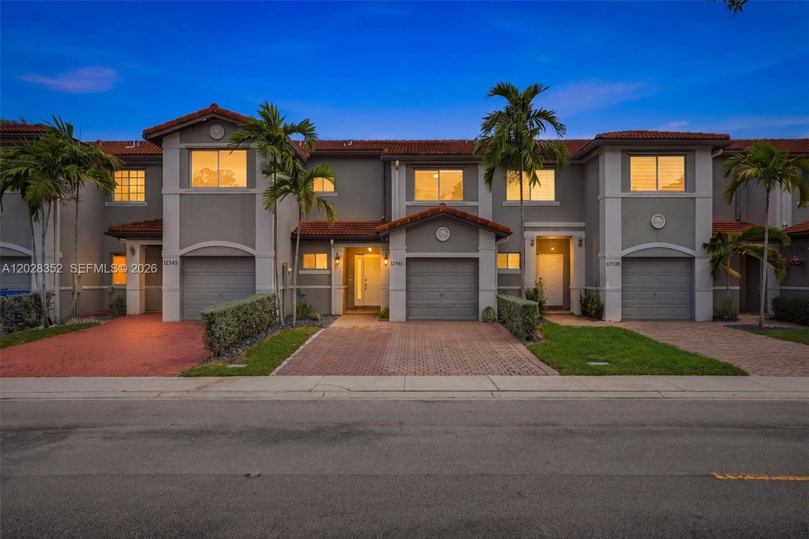 Beautifully renovated 2-bedroom, 2.5-bath townhouse with a one-car garage and extended driveway to park up to 2 vehicles, located in the sought-after gated community of Monarch Lakes in Miramar. Showcasing Mediterranean-inspired architecture with stucco exteriors and classic barrel tile roofs, this residence offers both charm and functionality in a prime South Florida location. Renovated open kitchen with wood cabinets, granite countertops, and stainless steel appliances. Primary bedroom with walk-in closet and a balcony. Upper level with flex space, ideal for a home office. Property additional features include renovated half bathroom on the first floor, tile flooring throughout the first level, and warm hardwood flooring upstairs, AC 2021, tankless water heater 2019, newer washer and dryer, pipes throughout the entire home replaced in 2022, and roof 2016. Enjoy an oversized backyard, ideal for entertaining outdoors. Community amenities include pool, playground, and walking trail. Low HOA fee covers landscaping, exterior paint, irrigation system, security rover, garbage, and recycling. Conveniently located near I-75, the Florida Turnpike, shopping, dining, parks, and top-rated A schools.