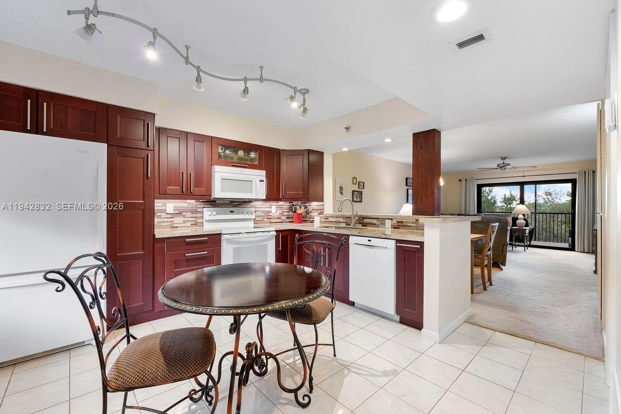 Welcome to your beautifully remodeled 2-bedroom, 2-bath condo in the heart of Cypress Bend—where comfort, convenience, and an active South Florida lifestyle come together. Step into a chef-inspired kitchen featuring sleek granite countertops, rich wood cabinetry, generous counter space, and two spacious pantries designed to keep all your kitchen essentials organized and within reach. Both bathrooms have been tastefully updated, and impact windows and impact-rated sliding doors provide peace of mind throughout. Enjoy quiet mornings on your screened-in patio, overlooking the canal and lush greenery—your own private retreat. Additional upgrades include an electric panel (2015), A/C (2015), water heater (2025), and a laundry room with a full-size washer and dryer. Cypress Bend offers resort-style amenities including scenic walking trails, tennis/pickleball courts, fitness center, playground, and two clubhouses—all just minutes to the Turnpike, I-95, beaches, dining, and shopping. No leasing for the first 2 years. Association requires a minimum credit score of 670. Come experience the vibrant, easy living Cypress Bend is known for. Buyer can get an "NON-WARRANTABLE CONVENTIONAL LOAN." If you don't have a lender who works with these kinds of loans, I can recommend someone.
