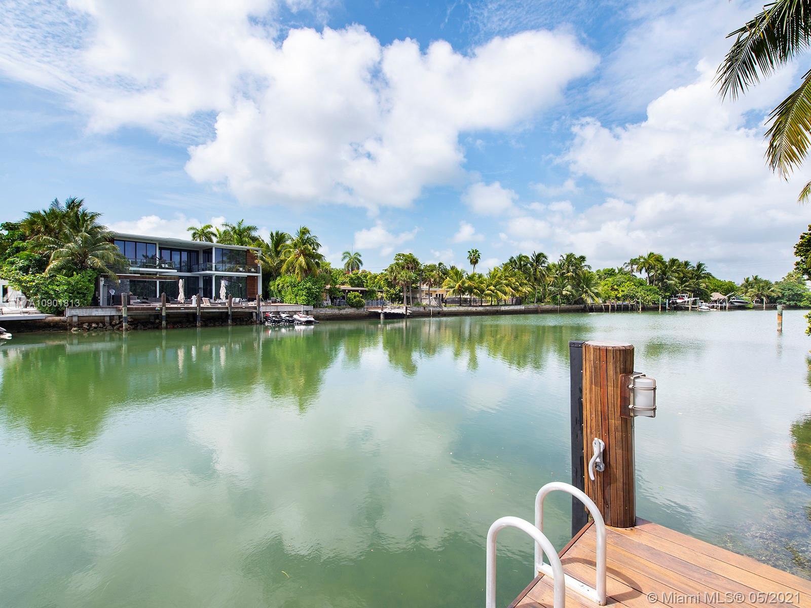 Centrally located in Miami Beach on a peaceful cul-de-sac street, this sleek modern residence has a spacious open floor plan with a beautiful interior garden and breathtaking scenery. Built in 2014, this home comes with luxurious amenities such as a living room with fireplace, a family room with water and pool views, a modern kitchen with granite countertops, wine cellar, and a second out dining are by a summer kitchen with pizza oven. Offering 5,132 Living SF, this 7 BD 7 BA residence combines concrete and wood flooring throughout the home. The master suite has two oversized terraces and a large walk-in closet. Outdoor amenities include a heated pool, IPE deck, a new boat lift, a dock, 70 FT of water frontage, and a large rooftop deck perfect for entertaining.