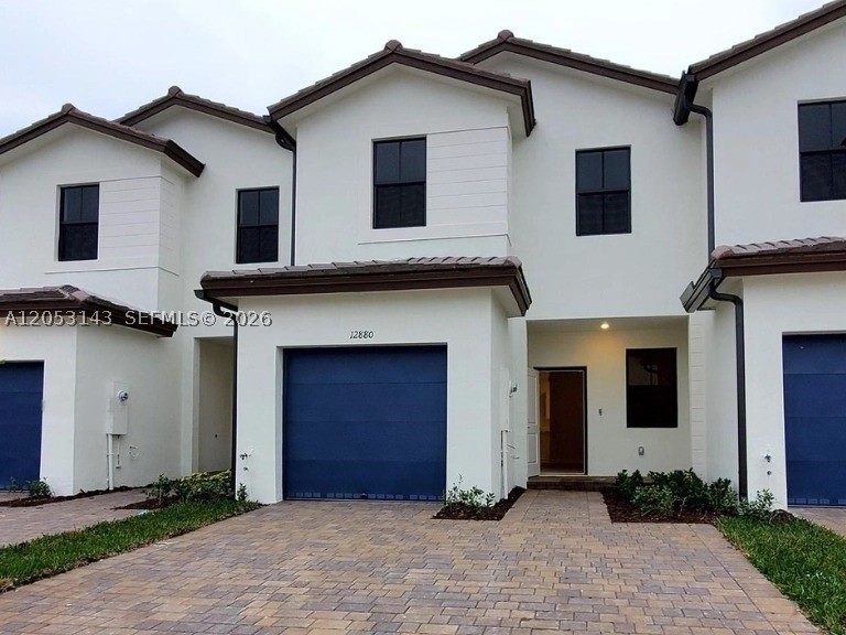 Beautiful 2023-built smart townhouse featuring 3 bedrooms, 2.5 bathrooms, impact windows and doors, and modern finishes throughout. Ceramic tile downstairs and carpet upstairs.  Great kitchen with stainless steel appliances. Convenient upstairs laundry with washer and dryer. Enjoy a private patio with turf for low maintenance.  1-car garage with epoxy floor, and driveway parking for 2 additional vehicles. Located in a newer community with a pool, fitness center, and easy access to major highways for a quick commute. Move-in ready!