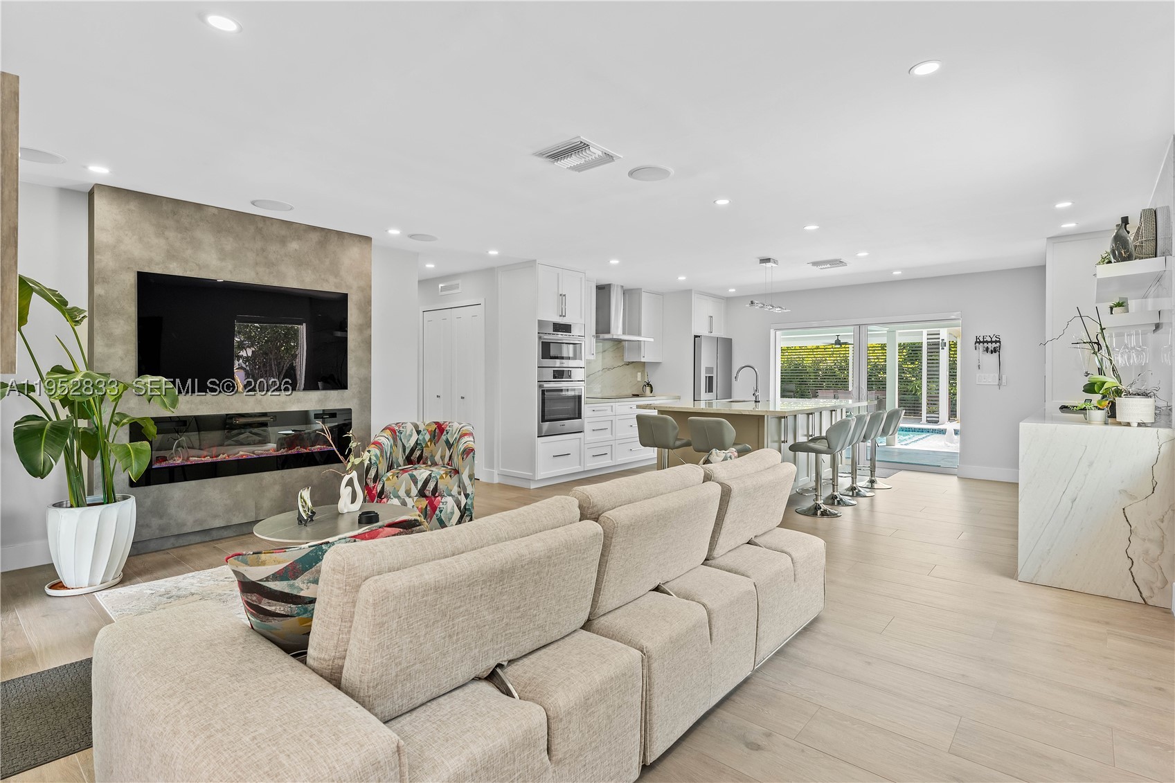A south Florida oasis.  Are you an empty nester looking for luxury without the added square footage?  Are you a professional looking for a home office within a compound?  Are you a couple with visiting guests who would prefer their privacy?  Unique and Rare Village of Palmetto Bay Lifestyle home.  With this turn-key purchase opportunity you get a compound formed by a renovated 3 bedroom 2 bathroom main residence, a third bathroom with access from the pool exclusively, a one bedroom, one bathroom detached private suite with its own living space, walk-in closet, full kitchen and laundry, and detached garage.  The main house has an open floor plan, a newly enclosed air-conditioned sunroom adding flexible living space.  Renovations since 2022 include updated electrical wiring throughout, separate wiring for a generator (not included), PBC piping leading to the completely new septic system, impact windows and doors, smart-home features. Situated on a large 17,000+ sq. ft. lot with heated saltwater pool, with whirlpool effect, marble deck flooring, multiple lighting settings, pergola, and fully equipped outdoor kitchen area. This can't miss property sits near shopping, and major roadways.  Discover its charm of one-of-a-kind tropical oasis!  Fully renovated starting in 2022, this property stands out from older comparables and is truly move-in ready. All the work upgrades were fully permitted with Architectural drawing available when asked.  Don’t miss this exceptional find!