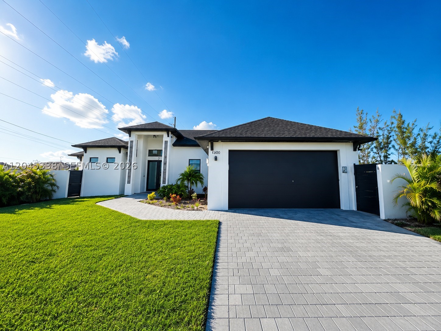 Stunning Contemporary Pool Home in the Heart of Cape Coral!
Welcome to this beautifully designed contemporary residence offering the perfect combination of luxury, comfort, and privacy. This exceptional home features a spacious open-concept floor plan with soaring tray ceilings, abundant natural light, and elegant porcelain tile flooring throughout.
The gourmet kitchen is the heart of the home, showcasing sleek European-style cabinetry, quartz countertops, stainless steel appliances, a large center island, and an additional wet bar with beverage refrigerator—ideal for entertaining.
The expansive living and dining areas seamlessly flow to the outdoor living space through oversized sliding glass doors, creating the ultimate indoor-outdoor Florida lifestyle.
The luxurious primary suite offers a spa-inspired bathroom featuring dual vessel sinks, oversized walk-in showers with designer tile finishes, modern black fixtures, and generous closet space. Additional bedrooms provide flexibility for family, guests, or a home office.
Step outside to your private tropical oasis complete with a custom heated pool and spa, spacious paved lanai, pergola seating area, lush landscaping, and a fully fenced backyard designed for maximum privacy and relaxation
Excellent location close to shopping, dining, schools, golf courses, and quick access to Fort Myers.
Move-in ready and meticulously maintained, this exceptional home offers the perfect blend of elegance and Florida resort-style living