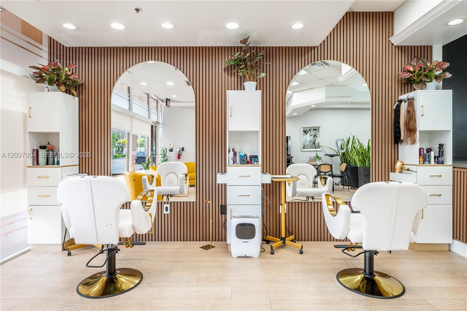 Turnkey opportunity to own a luxury, fully renovated beauty salon in the heart of Doral. Designed with impeccable taste, this space showcases a sophisticated blend of modern elegance and functionality, featuring custom finishes, designer lighting, and high-end furnishings throughout.
From the moment clients walk in, they are welcomed by a bright, stylish reception area with abundant natural light and a refined ambiance that elevates the entire experience. The open layout includes multiple upscale styling stations, sleek shampoo areas, manicure/pedicure section, and a private treatment room ideal for specialized services.
Every detail has been thoughtfully curated to reflect a premium brand image, including a dedicated coffee station, lounge area, and a visually appealing setup perfect for social media content and client engagement.
Located in a high-traffic shopping center with excellent visibility and ample parking, this salon offers the perfect combination of style, presence, and convenience.
Ideal for a stylist or entrepreneur ready to launch or elevate a luxury brand without the time and cost of building from scratch.