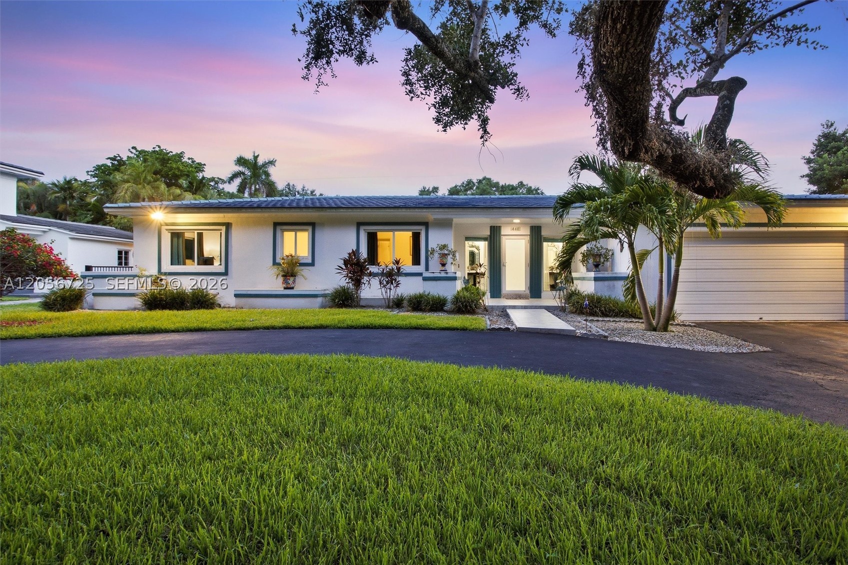 Don't miss this opportunity to purchase this beautiful home in the coveted "Platinum Triangle" in Coral Gables! This 4BD/2.5BA home on a mature tree-lined street perfect for bike rides and evening walks.  Home features natural lighting throughout, new 100-year blue ceramic tile roof, with matching blue-hue impact windows, and a circular driveway. Beautiful interior features white lacquer cabinetry, granite countertops, SS appliances, real wood floors in bedrooms, tiled living areas, dual master walk-ins closets, exquisitely renovated master bathroom with bidet, 2 shower heads and tub. Includes newer Lenox AC, new water heater, 2-car garage with new garage opener, auto sprinklers, newly reinforced wood trusses and backup 8 gauge steel hurricane shutters.  Modernized pool boasts new custom mosaic tile and a new reverse-cycle heat pump/chiller.  Pristine Art Deco furniture & artwork available for sale!