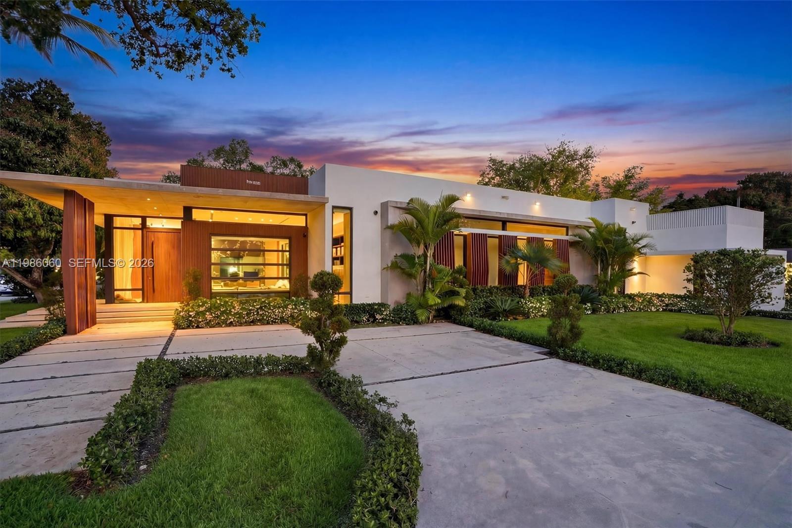 Villa Serene is a show-stopping corner lot estate where modern luxury meets coastal elegance, just steps from Biscayne Bay. Set on a 17,880 sq ft corner lot, this residence offers over 5,100 sq ft of refined living space with soaring 12-ft ceilings and imported Italian wood floors throughout. Designed for seamless indoor-outdoor living, every room opens to a resort-style saltwater pool, creating a private oasis ideal for both relaxation and entertaining. The chef’s kitchen features top-of-the-line Thermador appliances, a built-in hibachi grill, wine bar, and a pass-through to the outdoor kitchen. All bedrooms are en-suite, offering comfort and privacy. Smart home upgrades include Lutron lighting, whole-home water filtration, EV chargers, a 33kW generator, and advanced security. Additional highlights include double washers and dryers and expansive entertaining areas. Located in one of Miami Shores’ most desirable neighborhoods, Villa Serene is a rare turnkey opportunity and one of the area’s finest homes.   
 
*5th bedroom is a garage conversion - Furniture is negotiable