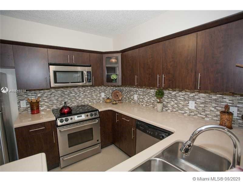 ONLY ONE CAR IS ALLOW PER ASSOCIATION *  Cozy 1/1 condo with lots of upgrades * 1st floor lenai unit has unique outdoor patio * Chocolate wood flooring, quartz counter top, modern glass tile back-splash, and stainless steel appliances * Spacious closets * Bath vanity with quartz counter top * Stacked washer/dryer * Enclave at Doral has tennis courts, fountains, lakes, pools, hot tubs, fitness center, and security. 24-hr showing appointment. Property will be available after July 1st 2021.