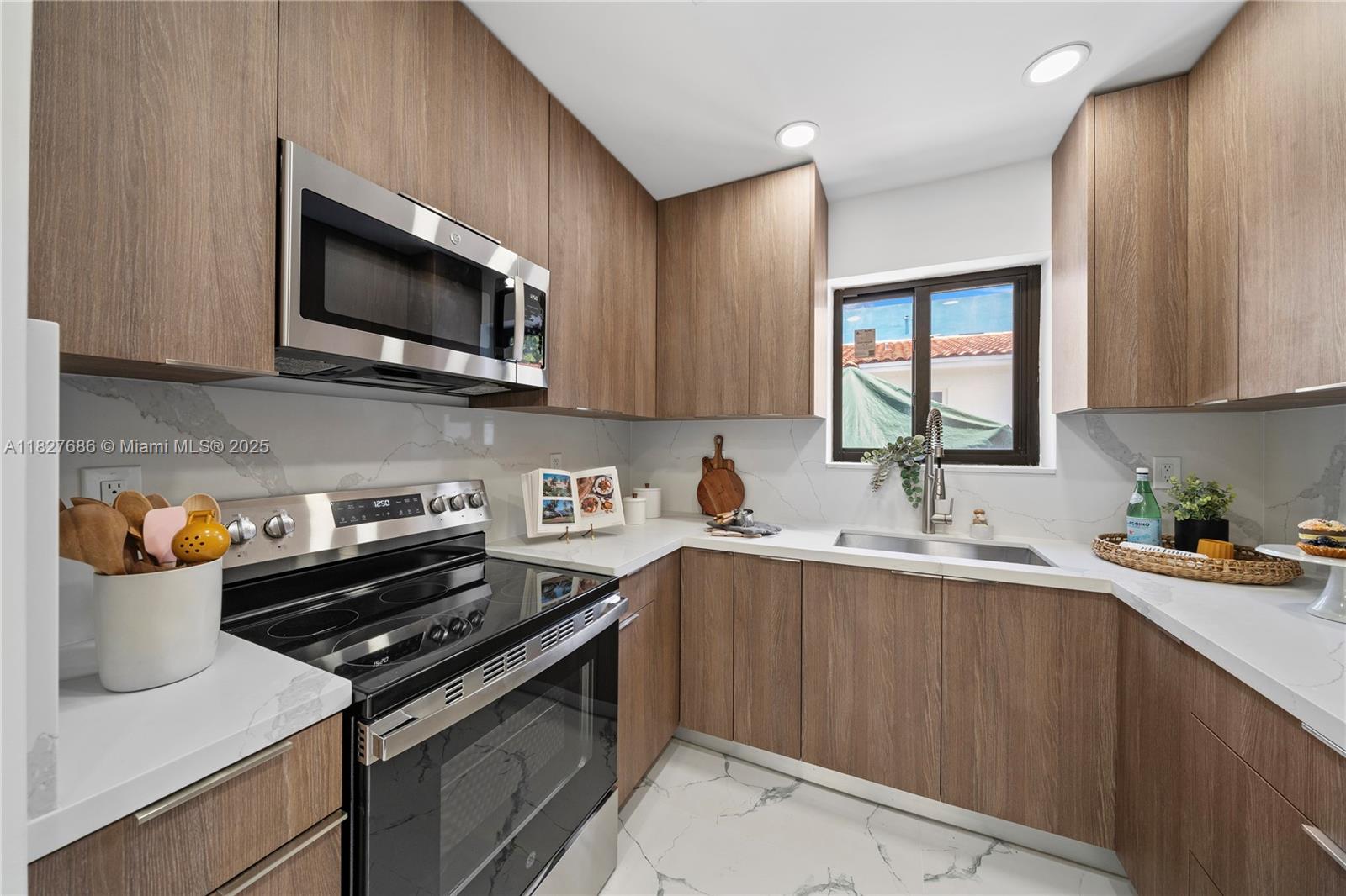 Discover a stunning modern living space that boasts updated features, including elegant countertops, high-end stainless steel appliances, and chic fixtures. The spacious open-concept living area is perfect for both relaxation and entertaining, enhanced by expansive impact windows that illuminate the room with abundant natural light. Retreat to the two generously sized bedrooms, designed to accommodate your furnishings and storage needs, creating the perfect sanctuary for unwinding. Experience the luxurious comfort of the beautifully updated bathrooms, ensuring convenience for you and your guests alike. Nestled in a prime location, this residence offers you the very best in city living, making it the perfect place to call home.