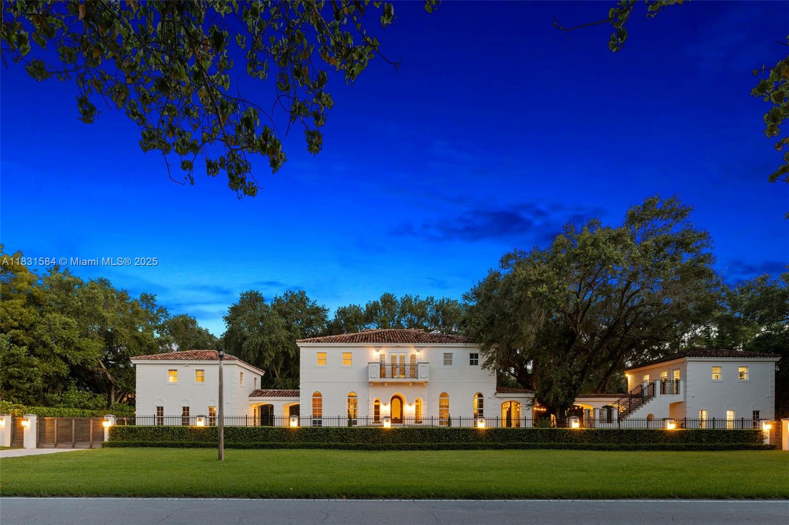 A custom-built estate with architectural provenance in a prime Coral Gables location, Sunset Villa offers timeless design enhanced by recent upgrades including new flooring & new kitchen. The property is comprised of 3 distinct structures offering exceptional flexibility. The main residence features 4 large bedrooms surrounding a central den, with expansive living spaces and a bright open kitchen below—all with soaring 14’ ceilings. Connected by breezeways, 2 guest suites sit above the 2-car garage, while a separate 2-story flex space serves as a gym (w/sauna), office, and/or wellness retreat. Mature oak trees and multiple covered terraces and patios create ideal settings for entertaining or relaxing. Fully gated and equipped with a smart-home system for audio, lighting, and security.