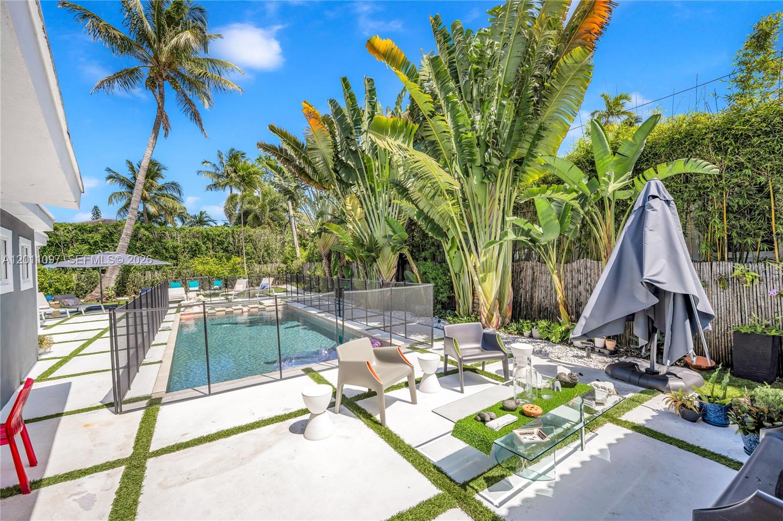 Step outside to your private tropical retreat situated on the oversized 9,147 SQFT lot in prime Miami Beach Lakeview neighborhood, positioned directly across from Fisher Park. This exceptional property offers one of the most desirable locations in Miami Beach, combining tranquil park views with close proximity to the beach, top schools, shopping, dining, and all the best of Miami living.

Outdoor amenities include marble tile decking, a heated saltwater pool and spa, covered dining area, four outdoor Sonos speakers, and parking for up to six vehicles.

This partially renovated 4-bedroom, 3-bath residence blends modern luxury with timeless design. Interior highlights include hardwood floors, slat wood and exposed beam ceilings, impact windows and doors, and an integrated indoor speaker system throughout. The gourmet Italian-style kitchen features Carrara marble countertops, a breakfast bar, oversized island, Sub-Zero refrigerator and freezer, and a Wolf dual-fuel gas range with electric oven.