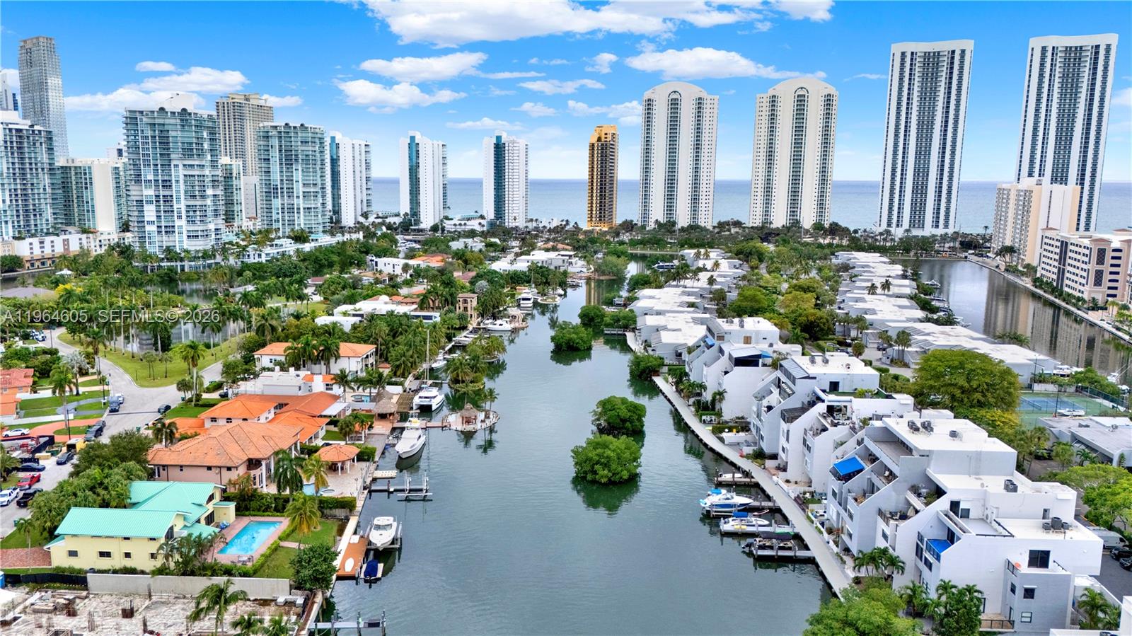 Penthouse residence in the exclusive gated community of Poinciana Island in Sunny Isles Beach. This 2-bedroom, 2.5-bath unit offers beautiful Intracoastal views and an ample private terrace perfect for outdoor living. Bright and spacious layout featuring large bedrooms, generous closets, abundant natural light, covered garage, and two private terraces—one with potential to expand living space. Ideal for full-time or seasonal living and ready for your personal updates. Resort-style amenities include pools, tennis courts, marina access, boardwalk, and private beach access across the street. Pet-friendly community near top-rated schools, Bal Harbour Shops, dining, and houses of worship.