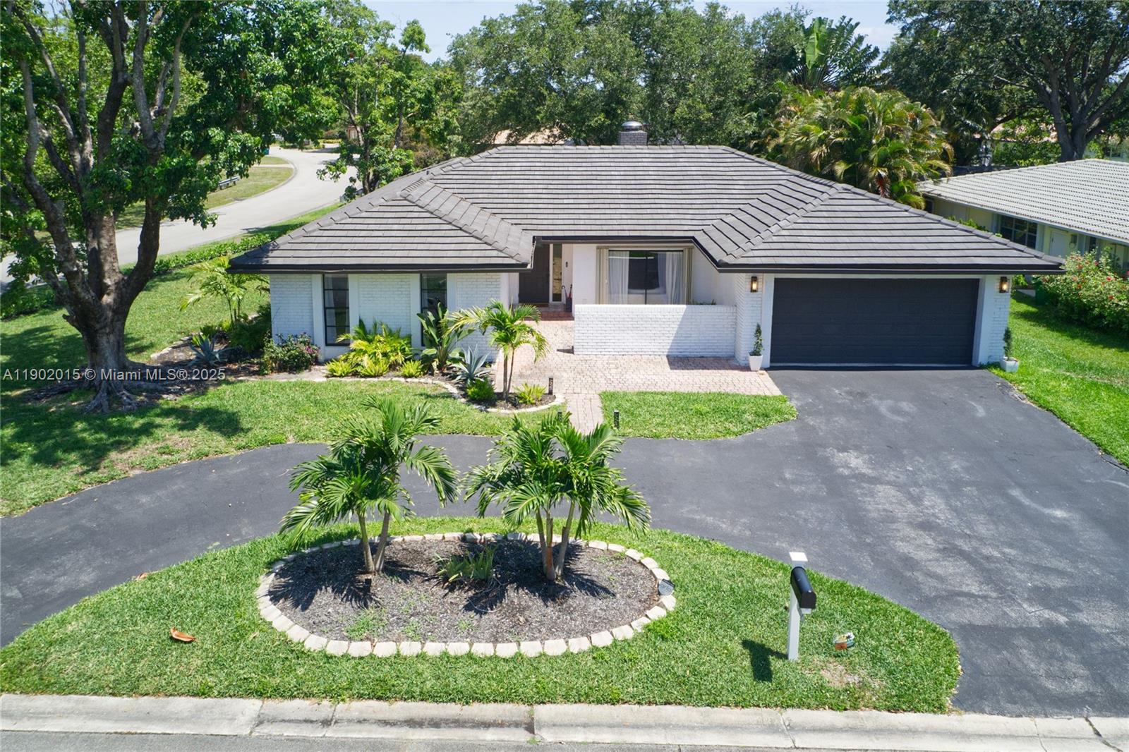 Experience elevated living in this reimagined Coral Springs retreat. Set on an 11,375 sq ft corner lot with serene canal views, this fully renovated 4-bed, 2-bath residence showcases soaring ceilings, refined finishes, and a striking double-sided fireplace as its centerpiece. Enjoy effortless indoor-outdoor living on the expansive terrace beside a sparkling pool with new heater, framed by lush landscaping for total privacy. Every detail shines—from the designer kitchen and contemporary baths to the new roof, A/C, and main panel. With a 2-car garage, ample parking, and shutters throughout, this turnkey home defines luxury, comfort, and timeless sophistication.