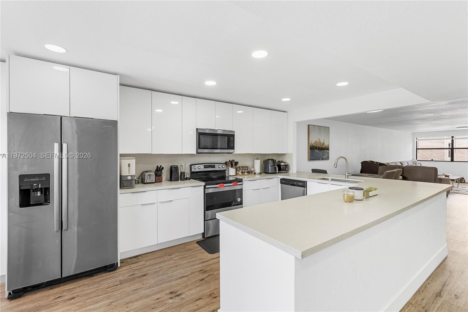 Step into a beautifully reimagined residence where modern elegance meets effortless comfort. This fully renovated home shines from the moment you walk in — bright, pristine, and thoughtfully designed with today’s buyer in mind.

The stunning contemporary kitchen is the heart of the home, featuring sleek high-gloss white cabinetry, luxurious quartz countertops, and a clean, sophisticated aesthetic that feels both timeless and on-trend. Every detail throughout has been carefully updated with refined finishes and a cohesive design palette.

The spacious living area offers flexibility and flow — perfect for relaxing or entertaining — while still providing the convenience of a dedicated utility room with a full-size washer and dryer.

Beyond your front door, an extraordinary lifestyle awaits. Enjoy resort-style amenities including sparkling pools, a state-of-the-art fitness center, club rooms, social activities, and live performances in a spectacular 1,000-seat theater. Whether you’re seeking vibrant social engagement or peaceful, elegant surroundings, you’ll find it here.

Attractively priced and truly move-in ready, this is your opportunity to enjoy effortless living in a beautifully updated home.

Come see why this one feels different the moment you walk in.