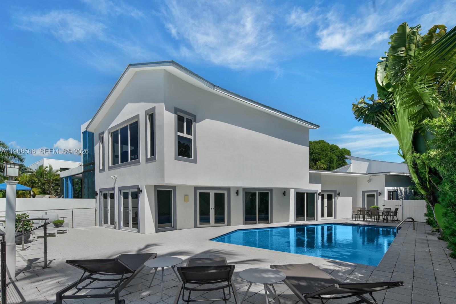 Your dream home awaits in Normandy Isles! Magnificent waterfront home in guard-gated Community, walking distance from the golf course. Stunning contemporary architecture,  this home features 5 bedrooms + den, open flow dining and living room layout. White glass Floor throughout, Modern chef's kitchen with top of the line Thermador appliances, a magnificent Wine room with glass walls. Hurricane impact windows and doors. A spacious 2nd Floor master suite with direct views to the Bay, large walk-in close and master bathroom.  A private Guest room on other end of the home on second Floor. Private 60 foot dock. This home is a must see!