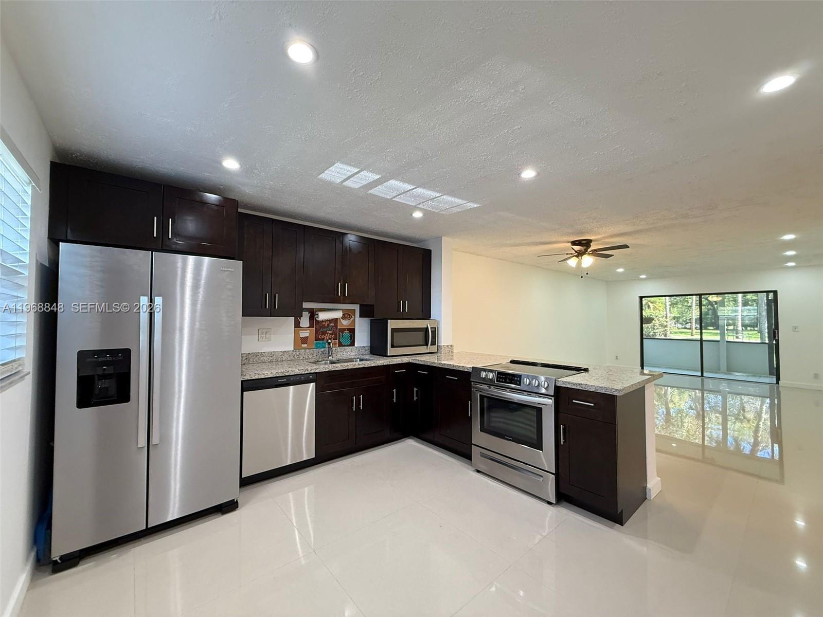Stunning renovated first-floor apartment with 1,270 sqft (including Patio). This spacious unit features a modern open kitchen with stainless steel appliances, a stylish bar area, and abundant natural light. Upgrades include new A/C (2025),new roof(2025),washer and dryer(2023), new refrigerator (2025), garbage disposal (2019), and a new elevator (2025). The apartment offers a large walk-in closet, serene garden views, and convenient parking in front of the unit. Condo fees include basic cable, Internet, water, and sewer. Ideally located 5 minutes from the Turnpike,15 minutes from I-95, 5 minutes from Walmart and Commercial Blvd,and close to shopping plazas,restaurants,and parks.This peaceful community combines comfort, convenience,and modern upgrades—making it the perfect place to call home.  AN OPPORTUNITY LIKE THIS IS RARE AND WILL BE GONE IN DAYS—SCHEDULE YOUR SHOWING BEFORE IT’S SOLD!
