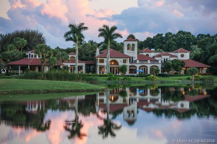 Situated on 2 premier lots with over over one acre of exquisite property, this spectacular estate presents truly panoramic views of the lake and fairways beyond. Boasting nearly 12,000 square feet of actual living space on one story and offering 7 bedrooms and 8.5 baths, this home is truly a compound. Located on a private cul-de-sac, with just over 300' of lake frontage and offering exquisite details throughout from a circular drive to the porte-cochere entrance and elegant, old French Castle doors, to an