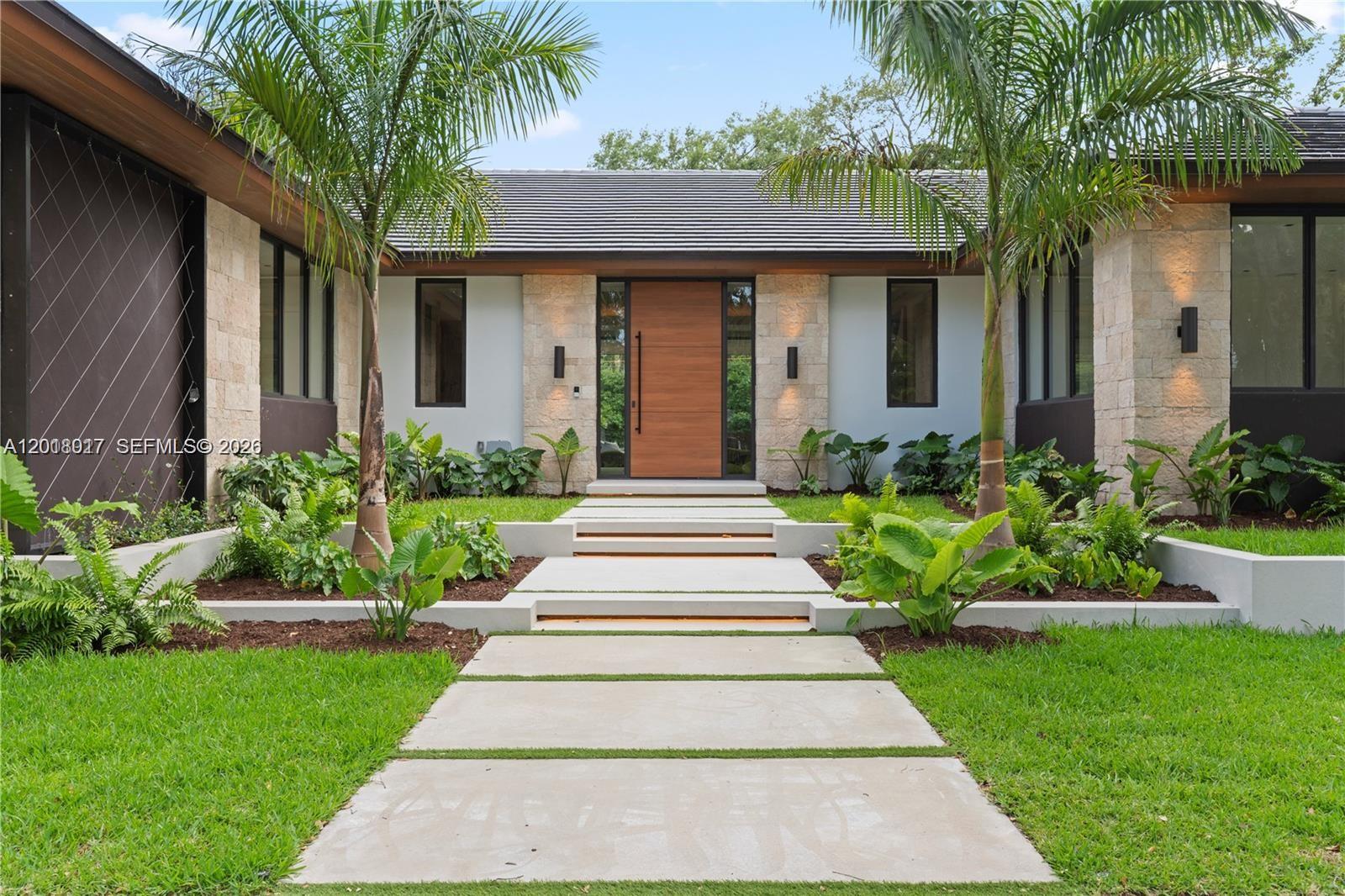 Discover Dadeland Home, a new-construction architectural statement just minutes from Dadeland Mall, where cutting-edge technology meets timeless luxury. This 5 bedroom, 6.5 bath residence offers 4,620 SF on an expansive 23,037 Sq.Ft lot. The bespoke European style kitchen showcases natural stone finishes, Sub-Zero & Wolf appliances, and a custom designed pantry, complemented by porcelain flooring, designer LED lighting, and elevated finishes throughout. Custom built closets are included in every bedroom, and the laundry room comes fully equipped with dual washers and dryers. A fully integrated smart home system controls audio, lighting, and motorized window treatments, while surveillance cameras and an advanced alarm system provide complete peace of mind. The open concept living areas flow through ES Windows impact sliders to a resort style oasis, anchored by a saltwater pool and a fully equipped summer kitchen with premium Coyote BBQ designed for year round South Florida entertaining. A rare turnkey opportunity blending luxury, technology, and prime location.