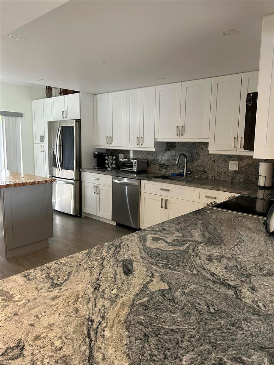 Welcome to a charming residence in the heart of Deerfield Beach! This inviting fully remodeled home has spacious living areas filled with natural light, a modern kitchen with hi-end appliances, and a cozy backyard appropriate for relaxation. The property is located in a tranquil neighborhood with convenient access to local amenities and beautiful parks. Enjoy the blend of comfort and convenience in this delightful house. Don't miss the opportunity to make it your own!