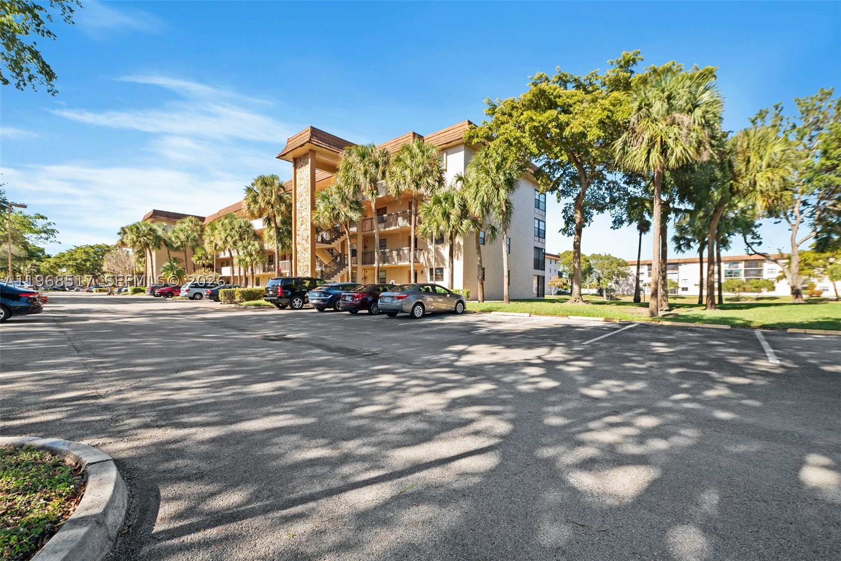 Spacious 2-bedroom, 2-bathroom third-floor CORNER UNIT offering serene lake and pool views—one of the best locations in the building. This well-maintained condo features over 1,250 square feet of living space filled with abundant natural light. Enjoy a dedicated laundry room equipped with a full-size washer and dryer, plus an additional storage closet. The eat-in kitchen is appointed with maple-tone cabinetry, granite countertops, and a matching backsplash. The open dining and living room combination showcases Brazilian wood laminate flooring, ideal for entertaining. Both bedrooms are generously sized and include walk-in closets. Relax year-round in the enclosed Florida room/patio—perfect for morning coffee or evening wine. Schedule your showing today.