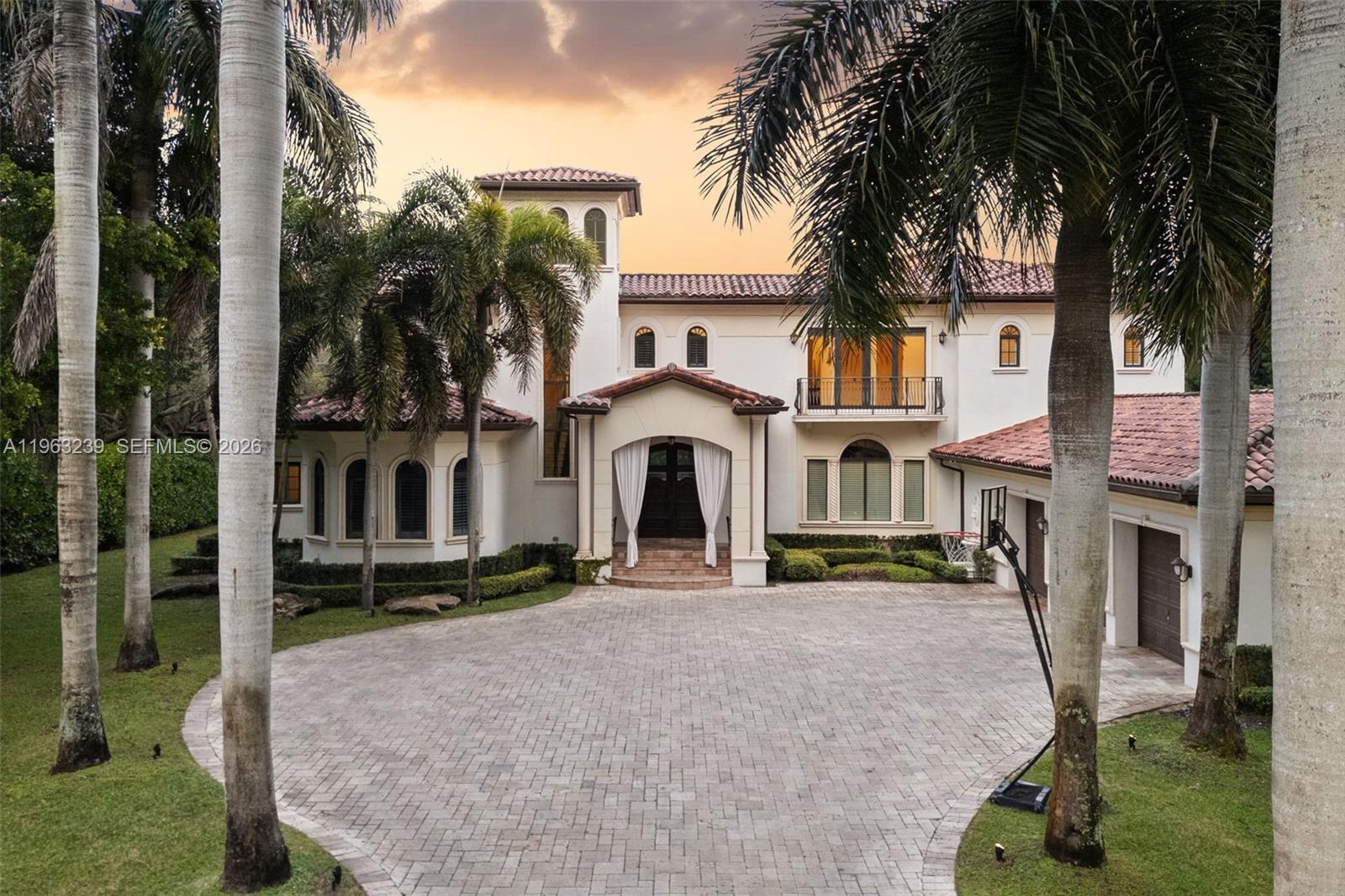 Mediterranean masterpiece on secluded Killian Park Rd in the heart of Pinecrest. This nearly 11,000 total SF estate sits on almost an acre of lush, private grounds and offers the ideal layout for everyday living and effortless entertaining. Behind a gated entry, discover soaring ceilings and walls of windows that flood the home with natural light and showcase tranquil garden views from nearly every room. The gourmet chef’s kitchen anchors multiple entertaining spaces, while all six bedrooms are en-suite, complemented by a private office and an upstairs loft. The expansive ~1,200 SF primary suite features dual walk-in closets, spa-like bath with double shower, wet bar, and private terrace. Elevator access and a three-car indoor garage provide ultimate convenience. Outdoors, enjoy a true backyard oasis with a massive pool surrounded by mature oak, avocado, mango trees, and manicured hedges—perfect for entertaining or quiet family enjoyment. Additional features include complete impact glass windows, smart-home Savant automation, fireplace, and meticulous craftsmanship throughout. Ideally located within a few miles of top-rated schools (Gulliver, Pinecrest, Palmetto, etc.) and fine dining, shopping, and cultural attractions, this elegant estate seamlessly blends luxury, comfort, and privacy—an exceptional place to call home.