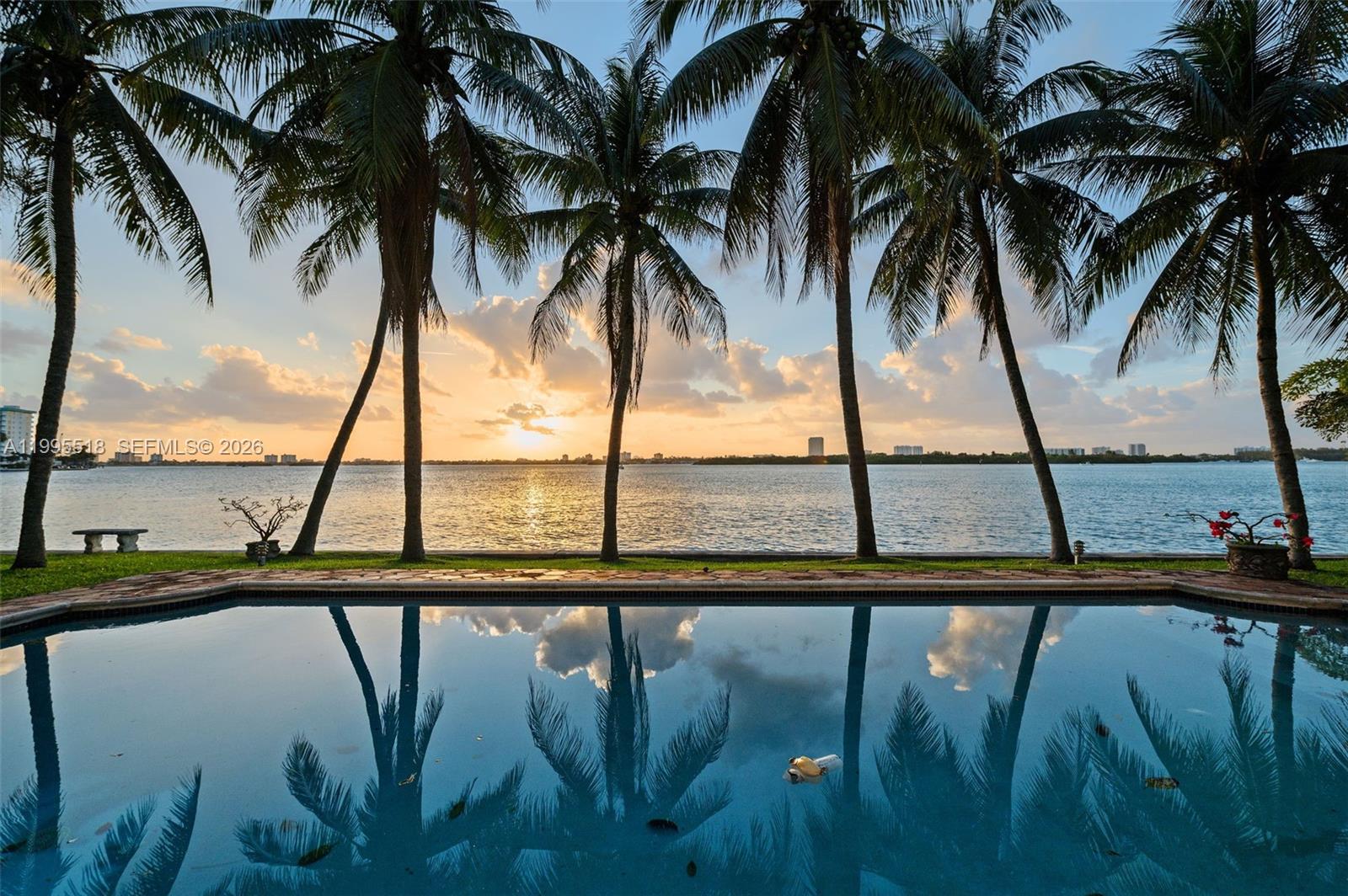 Once in a Generation Bal Harbour Village Opportunity. Offered for the first time since 1979, this 20,570 SF bayfront property is a stunning setting for creating the definitive South Florida sanctuary estate. Days begin with uplifting water vistas paired w/the classic calls of gliding gulls; they end with masterpiece sunsets mirrored across the bay. Ocean breezes sweep constantly thru the palms & pools of this coveted gated enclave. Swim or paddle to the Haulover Sandbar fronting the property to bask on the bay. Stroll thru a private pedestrian gate to sunbathe on world-famous beaches. Take a quick turn around the shoreline to cruise thru the Haulover Inlet onto the open ocean. And drive just 4 mins to indulge in the refined offerings of Bal Harbour Shops, an iconic nexus of the glitterati.