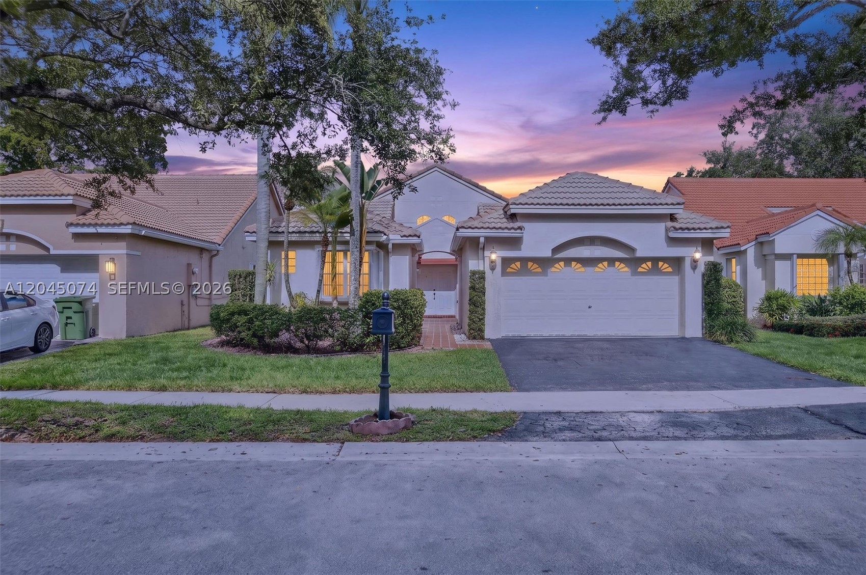 Peaceful lake views, soaring ceilings and one of the best locations in Weston, this is Hibiscus Island. Tucked inside this gated community is this beautifully maintained single-story home offering the perfect balance of privacy, convenience and timeless design. From the moment you walk through the front double door, you're welcomed by dramatic vaulted ceilings & an impressive wall of windows that fills the home with natural light. It's open and airy, a coveted layout that creates a sense of space that's hard to find. The tranquil lake views draw you in and provide a peaceful backdrop from many of the home's main living areas. The spacious primary suite is a true retreat with two walk-in closets, a generous ensuite bath with a soaking tub, separate shower & plenty of room to unwind. The bright eat-in kitchen overlooks the water and features brand-new granite countertops, new stainless-steel appliances, cozy breakfast nook & a newly installed vent hood system, perfect for those who love to cook. Step outside to enjoy two screened outdoor spaces: a peaceful rear screened lanai where you can relax and take in the calming lake views & a screened side patio offers endless possibilities for creating your own private oasis. Whether you're looking for the ease of single-story living, a two-car garage, walkability to highly rated schools, or simply a home that feels bright, peaceful & welcoming, this property delivers.
