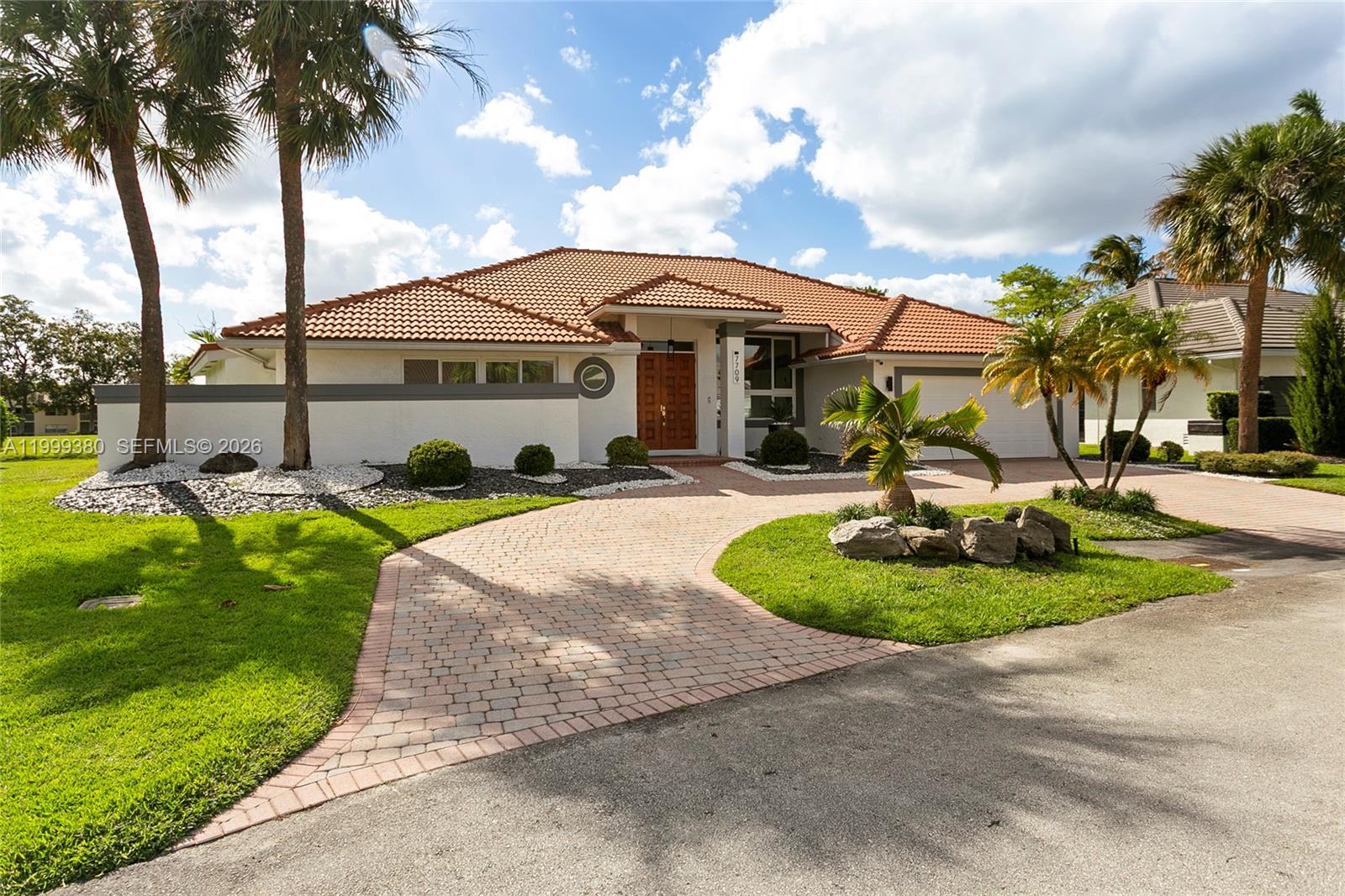 Step into luxury with this stunning, fully upgraded waterfront residence, where modern design meets cutting-edge smart living. Turnkey home, freshly painted inside and out, offering elegance, comfort, and innovation—enhanced by beautifully updated landscaping, a two-car garage, and breathtaking water and golf course views in the rear.
Rectified Italian porcelain tile flooring throughout, completely renovated home. State-of-the-art chef’s kitchen, with custom cabinetry, striking quartz waterfall countertops, and brand-new 2024 appliances. Beautiful chimney.
Impact windows throughout, a 2023 foam-insulated attic, a 2023 water heater, and a high-performance HVAC system. Fully equipped smart lighting system, smart sprinkler control panel, smart pool controls, and a unified security system for ultimate convenience and security.
Primary suite features a large bedroom, custom walk-in closets, beautifully remodeled, modern-designed bathrooms with high-end finishes. Spacious second bedroom with walk-in closets. Additional upgrades include new interior doors, renovated laundry room with cabinetry, designer lighting fixtures and window treatments.
Wine enthusiasts will love the climate-controlled, state-of-the-art wine cellar. Outdoor living with a pool, new outdoor cooktop, and water and golf course views. 
This residence offers the ultimate in luxury, technology, and lifestyle. A rare waterfront and golf course view opportunity—schedule your private showing today.