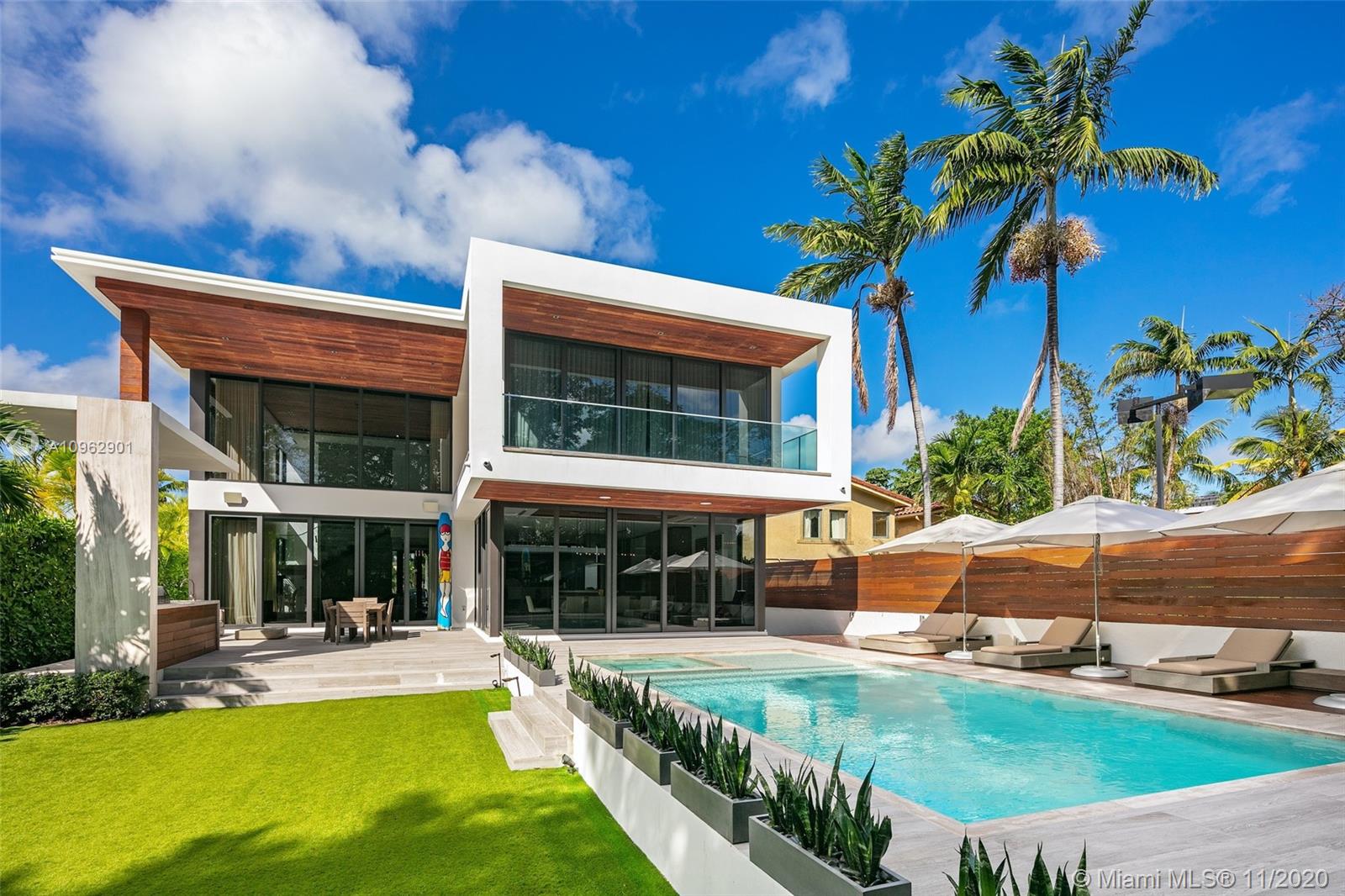 Impeccable modern architectural masterpiece envisioned by architect Kobi Karp, built by Todd Michael Glaser. Perfectly designed to maximize space & privacy, this stunning residence on oversized 11,820 SF lot is nestled behind private gates. True open concept blending the indoors & outdoors mixed with lush tropical landscaping creating a zen paradise. Highlights include a beautiful combination of natural stone, exposed concrete & Ipe wood, soaring 22’ ceilings, chef’s dream Poliform walnut kitchen  w/ double Sub Zero fridge, Wine cooler, marble floors, Lutron & Sonos smart home elements. The principal suite rivals the finest hotels w/ walls of glass & sumptuous spa-like bathroom. Outdoors, the grounds feature a detached cabana gym, heated pool, outdoor kitchen/BBQ.