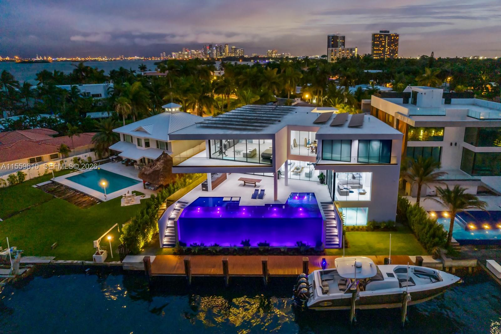 Stunning Bay/Canal Contemporary Residence- 100+ ft on deep water - New Construction (total of 12,924 SF under A/C).  Loaded with ultra luxury finishes and very little use - 35KM solar electric generator w/six Tesla power walls & Travertine exterior walls.  All custom lighting & sound throughout.  Unique glass elevator to all three levels.  Generous sized rooms and large closets.  Art Gallery, Office-Library, amazing 12 car garage, play room & wine cellar.  Breathtaking views of the Open Bay, City lights and tropical gardens from all rooms.  Huge covered Patio + Summer Kitchen w/50ft infinity edge pool.  Full dock & Boat Lift. Double gated 24/7 Island in the heart of Miami.  Minutes to Design District, Beaches, Downtown Miami & Bal Harbour.  Owner Financing Possible.