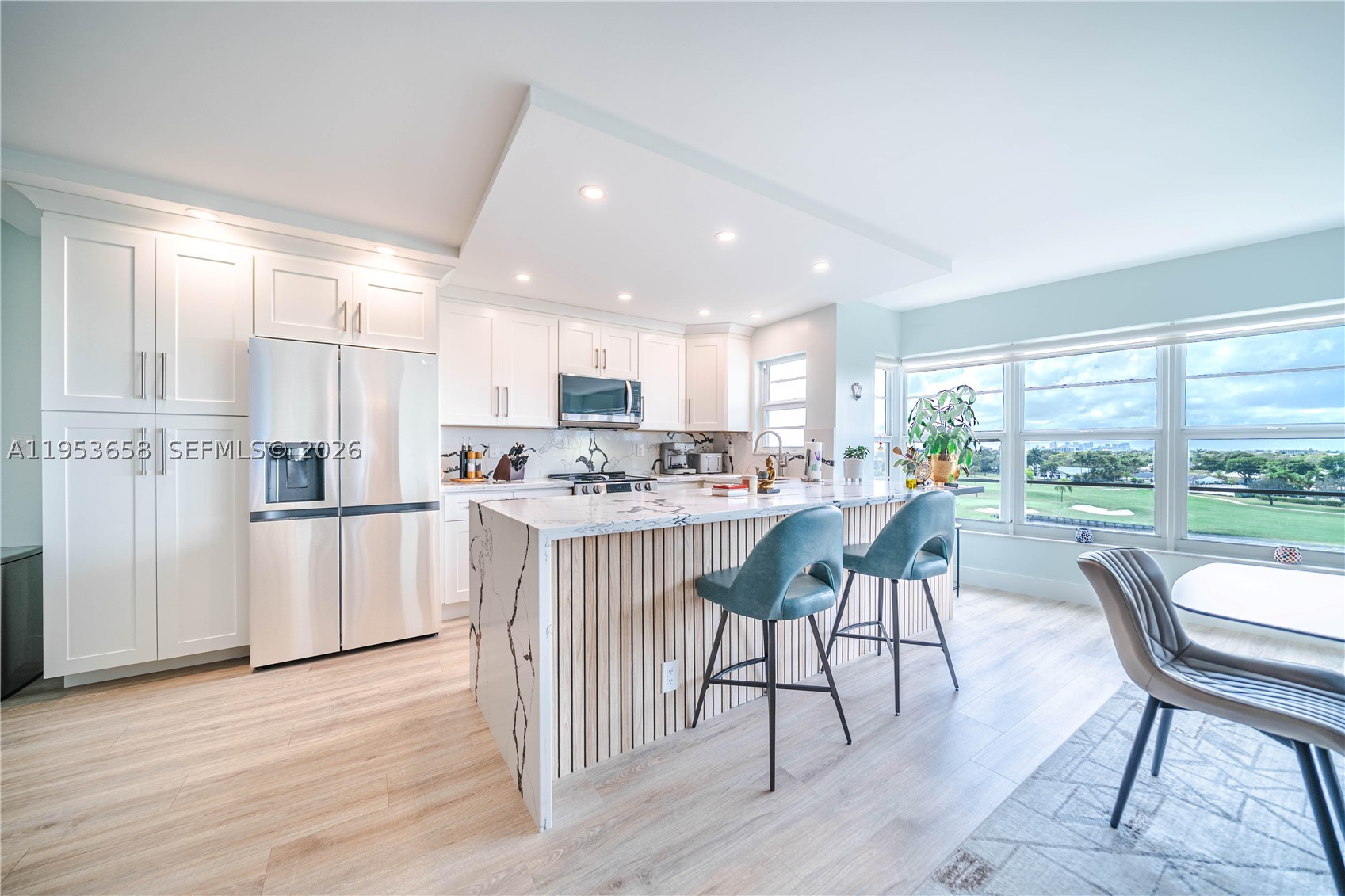 Beautifully renovated 2/2 condo with $100K in upgrades, sweeping views of Coral Ridge Country Club golf course and the Ft. Lauderdale skyline, just one mile from Lauderdale-by-the-Sea beach. Open living/dining area features stylish flooring, abundant natural light, high-end lighting and smooth ceilings. Modern kitchen with contemporary cabinetry, quartz waterfall countertops, upgraded LG appliances, new electric panel, and washer/dryer. Spacious primary suite has walk-in closet and en-suite bath, second bedroom with full bath ideal for guests or office. Well-managed building with secure entry, covered parking, funded reserves, no pending assessments, and passed inspections. Minutes to Cardinal Gibbons HS, Pinecrest, and Westminster Academy. Luxury, location, and value—don’t miss this “gem!”