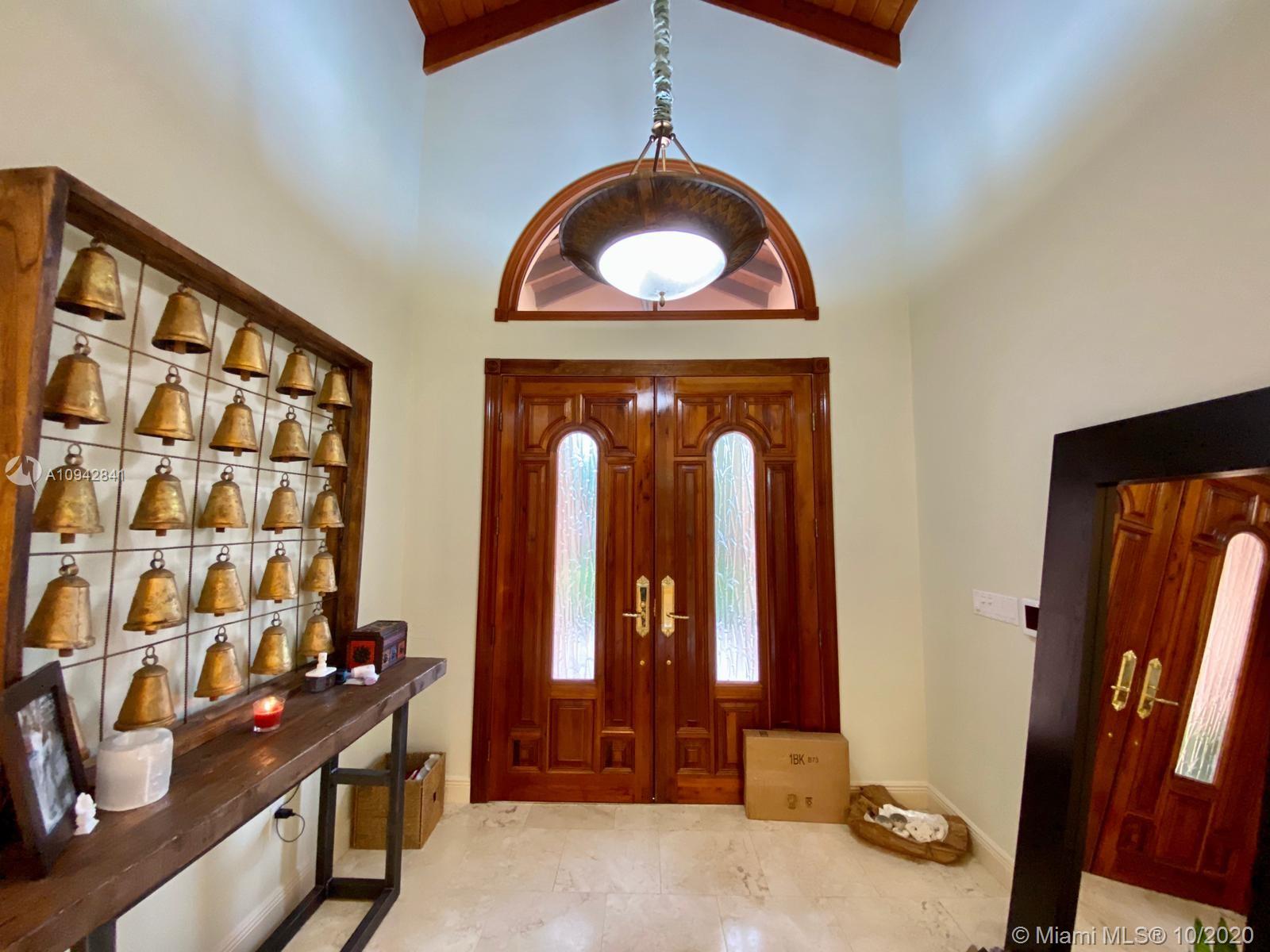 Unique and Exquisite corner property in Prestigious Cocoplum - home features 6 bedrooms with en-suite baths and wood finished closets. Large formal living room with volume ceilings, formal dining room overlooking the gardens, spacious family room with mahogany built-ins and views of the water and swimming pool. Second floor master suite and sitting area have lovely water views and a private terrace. 157ft water frontage with Private dock (Access to the bay), full house generator, the home-office, gym, sauna, movie theater/music studio complete this special offering. 18,843 sqft corner lot. New roof was installed in 2019.