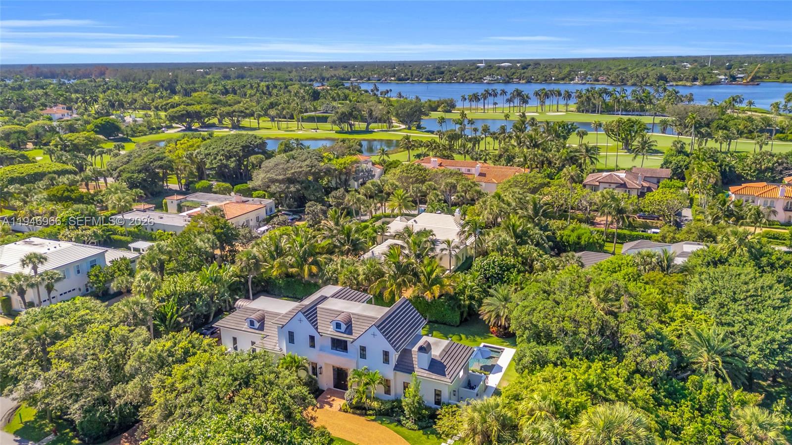 Located near the Jupiter Island Club and Golf Course, this 2023 British West Indies–inspired residence combines timeless architecture with modern coastal luxury. Main level features a gourmet kitchen, spacious living room with gas fireplace, dining area, private office, & a guest bedroom with ensuite bath. Upstairs, the owner’s suite offers 2 custom walk-in closets, balcony access, dual vanities, a walk-in glass shower, & coffee bar. 2 additional bedrooms share a luxurious connecting bath & open to an expansive balcony overlooking the pool. Perfect for entertaining, the outdoor spaces include a covered lanai with summer kitchen & gas fireplace, poolside dining patio outdoor shower, & a heated pool and spa with sun shelf. Highlights: impact-rated windows and doors, whole-home generator, propane gas system, landscape lighting, dual-zone AC, tankless water heater and DEEDED BEACH ACCESS. Enjoy refined island living just steps from Jupiter Island’s private club, golf course, and pristine beaches.