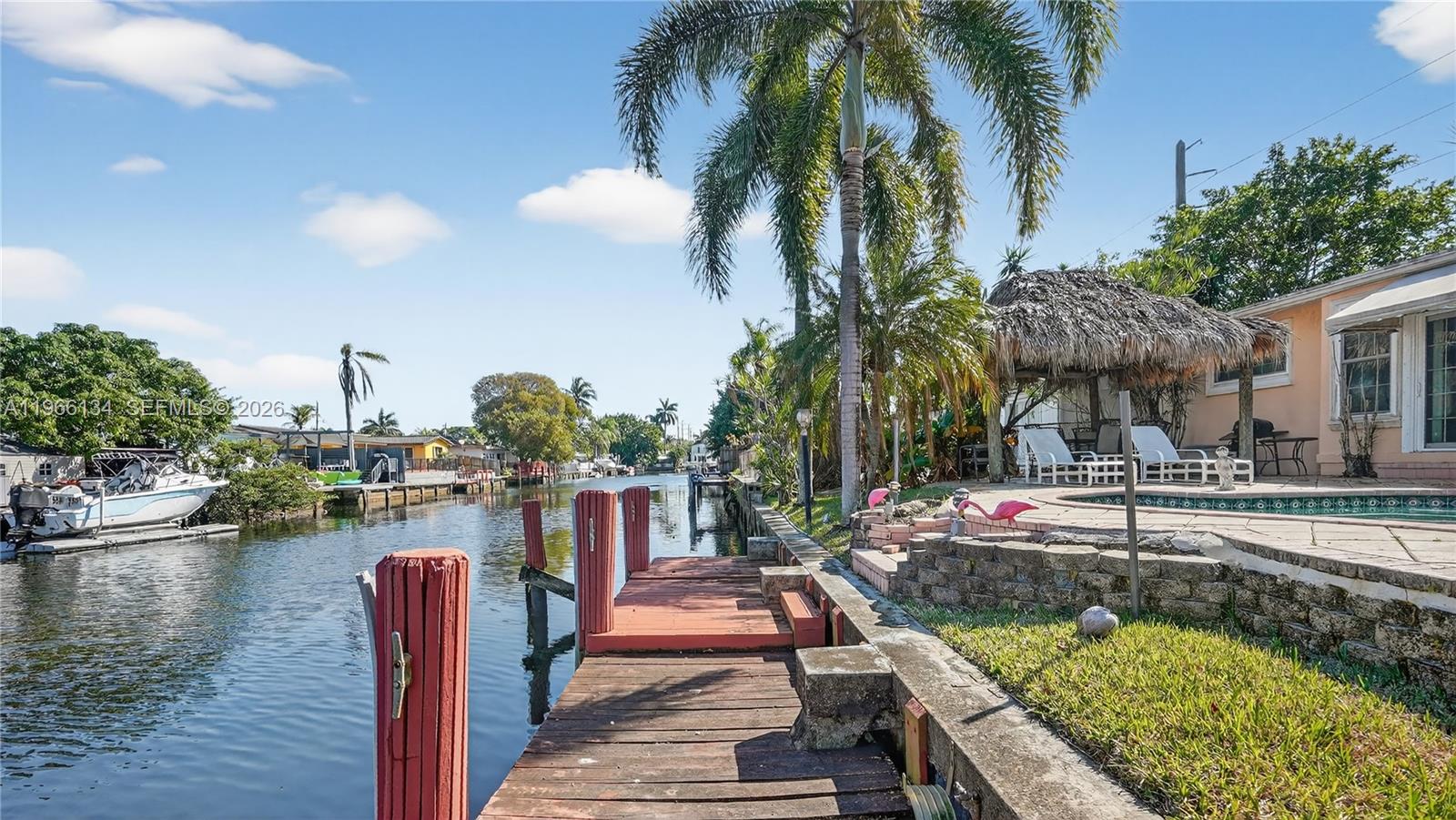 Bring your boat! This 3-bedroom, 3-bathroom 1950s waterfront home is in excellent condition and features original pinewood floors, impact windows, a new kitchen, two-car garage, pool, jacuzzi, and brand-new gas water heater.

The standout feature is the outdoor living: a canal-front pool and jacuzzi, a “chickee” hut for entertaining, and your own private boat dock providing direct ocean access. Embrace the “Old Florida” lifestyle with effortless indoor-outdoor living. At this price point, waterfront homes with ocean access in South Florida rarely come along—don’t miss this opportunity!