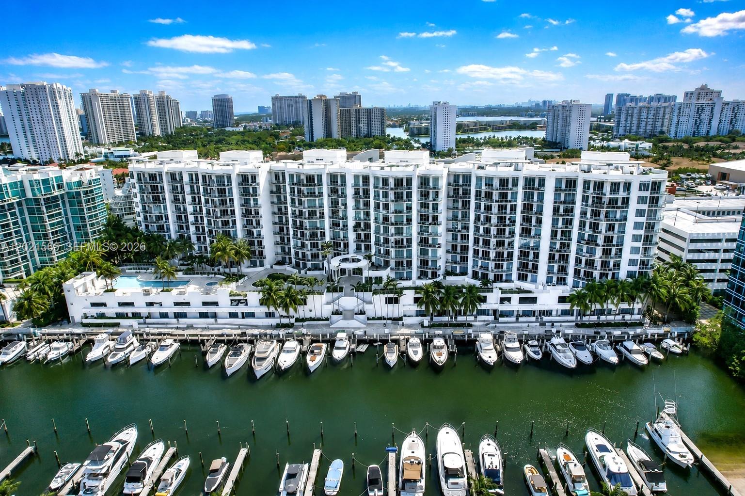Uptown Marina Lofts high-floor condo boasts stunning views from a balcony overlooking the waterfront, bay, marina, and city skyline. Soaring 11-foot ceilings, modern industrial elements, high-impact windows, and glass doors create a serene, light-filled living space. *Bedrooms: 1. The primary has a spectacular waterfront view, an oversized custom walk-in closet with lots of shelving and storage, along with a full bathroom. 2. A den that can be used as a home office or 2nd bedroom is next to the 2nd full bathroom. *Kitchen/Laundry: The open-concept kitchen has stainless steel appliances and expansive granite countertops. Washer and dryer are discreet in a closet. *Furnished: Condo available fully furnished-negotiable. Brand-new king-size Stearns & Foster Lux mattress ($4k value). *Amenities: State-of-the-art fitness center, large pool, sauna/steam, yoga room, tennis court (can pickleball), basketball, party room, and business center. *Security: Fob-secured access to a semi-private 8th-floor elevator that opens to only four residences. 24-hour front desk, security, and valet parking. One parking space. *Pets: Efficient elevators, staff, and a dog groomer a short walk away. *Walkability: A scenic boardwalk offers sunrise/sunset strolls for families and pets. Grocery, derma, dentist, salons/barbers, dry cleaner, bank, dining options, and one of Aventura’s top-rated schools. *Extended Neighborhood: Aventura Mall, Costco, Mount Sinai Medical, houses of worship, Sunny Isles Beach.
