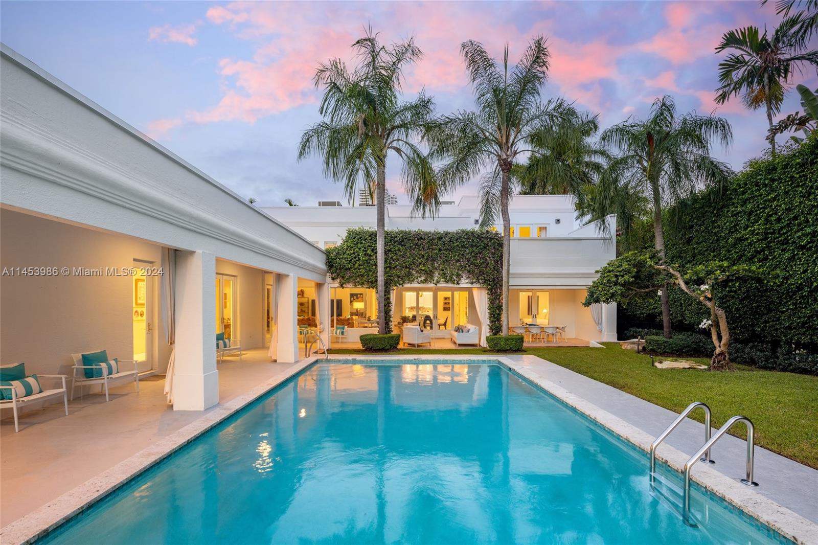 Palm Beach Meets Miami Beach! This beautiful Contemporary waterfront home sits on a lushly manicured, 16,200 SF west facing lot on guard-gated Allison Island! Inside the newly renovated modern & bright interiors you'll find large living spaces w/ dramatic double height ceilings, gourmet kitchen, family room, a 1,000 SF primary suite w/ attached office, massive 1st floor VIP suite & 3 large guest bedrooms w/ newly renovated en-suite baths. 
The outdoors is a tropical oasis w/ a large covered loggia & outdoor dining w/ retractable screens , resort style pool, & dock w/ boat lift. With 75 feet of WF & easy access to the bay this property is ideal for boaters. The home’s Western exposure will capture colorful sunsets over the water. Property is equipped w/ a 3-car garage & gated motor court.