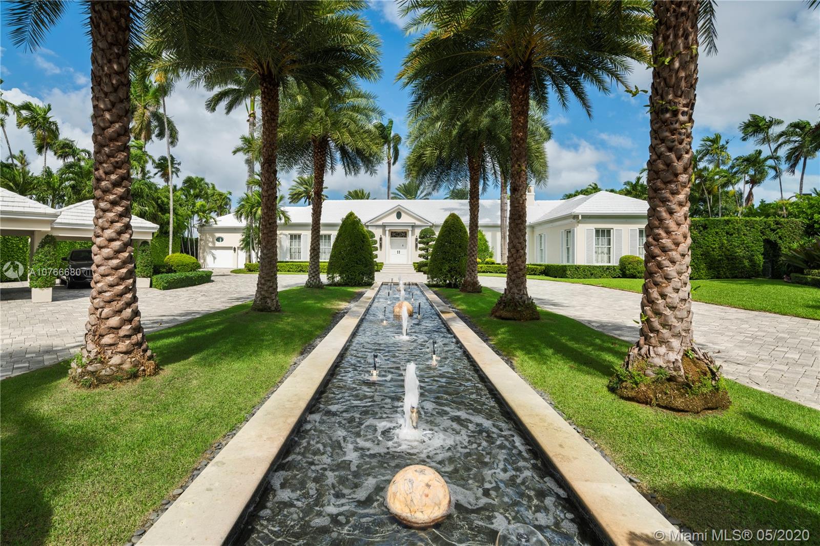 Enter through private gates & down tree-lined, meticulously manicured gardens to reach this regency style estate that exudes warmth, charm & sophistication. This Palm Beach style home has been built using the finest materials to create an elegant & timeless property. Boasting 4BR/5+1 BA this 7,725 total SF home sits upon a 37,578 SF lot on coveted, guard-gated Sunset Island I. Experience 165’ of WF & wide bay views in this impeccably designed waterfront home. Features: a waterfront gym w/ a spa room, modern, sleek open Poliform kitchen w/ top-of-the-line appliances, wine-cooler, 2-car garage & 3-car carport, expansive fresh-water lap pool, brand-new private boat dock, expansive master suite with his/her sinks & walk-in closets, a service entrance & a glass enclosed private office.