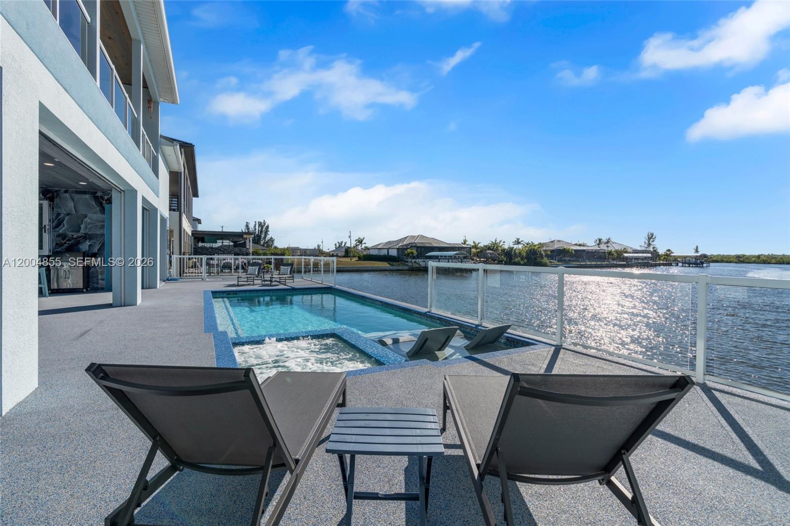 Experience modern coastal luxury in this custom-built 2025 waterfront home with direct sailboat access to the Gulf. Offering 3,784 square feet of beautifully crafted living space, this residence blends elegance with function.
The home features 3 oversized bedrooms, a private office, a theater/flex room with bar, and 4.5 bathrooms. Each bedroom includes an en-suite bath, while one guest suite offers a private washer and dryer—ideal for extended stays or multigenerational living. The chef’s kitchen impresses with a pot filler, two waterfall-edge islands with seating for eight, and a walk-in butler’s pantry with a second dishwasher—perfect for entertaining. Motion-activated kick lighting and dimmable lighting enhance ambiance throughout. Built for durability and efficiency, the home includes hurricane-impact windows and doors, Icynene insulation, a whole-home reverse osmosis system, and a Fuji septic system.
Outdoor living features retractable and hurricane screens, mini-split systems in the garage and lanai, and a built-in bug misting system. The lanai and pool area showcase premium FloCo rubber flooring—slip-resistant, cool-to-the-touch, and highly durable.A 1,200+ square foot air-conditioned garage with 17-foot ceilings and a door opening to the lanai completes this exceptional property.