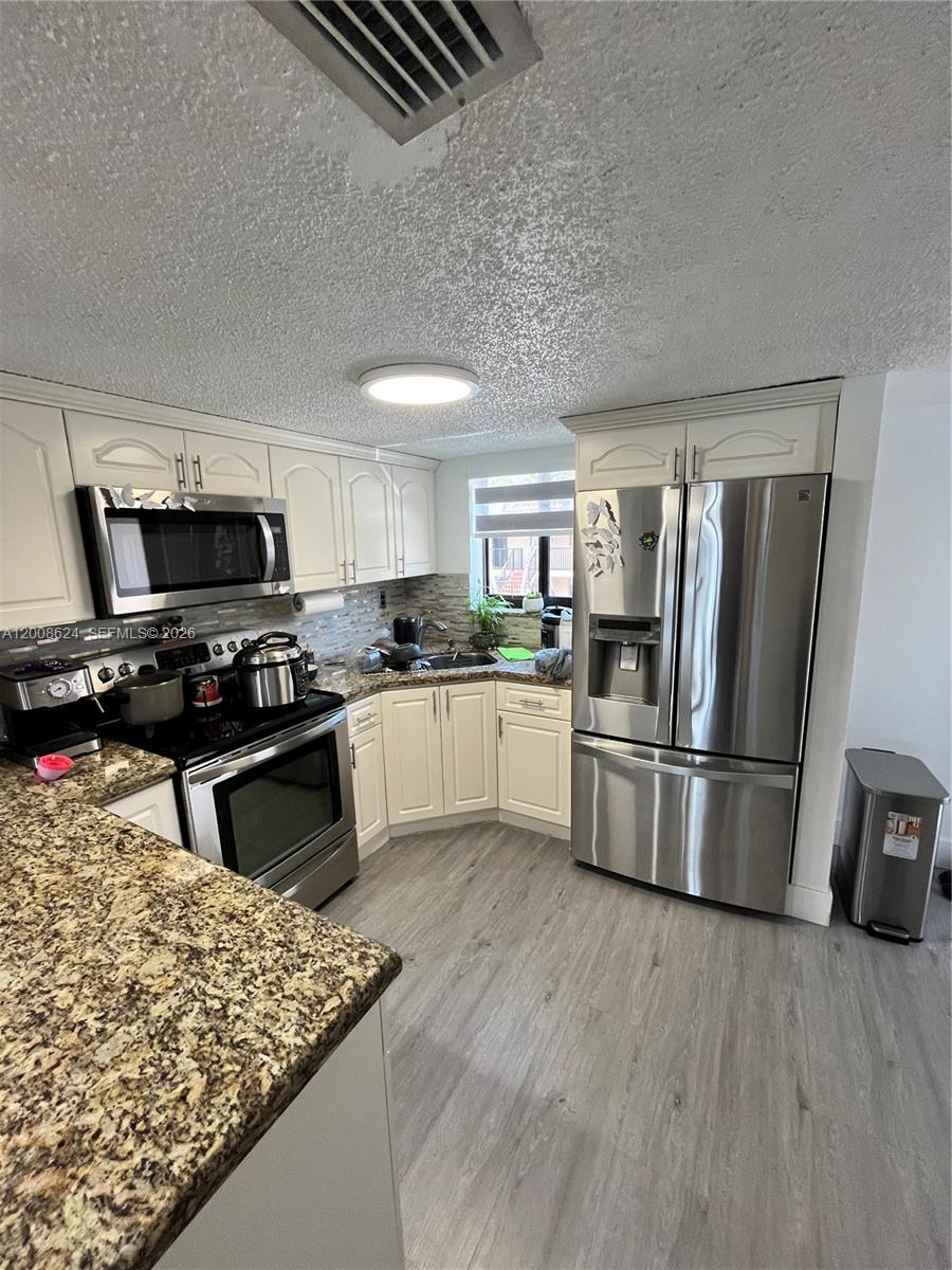 Bright two-level residence featuring 2 bedrooms and 1.5 bathrooms, offering a relaxing lifestyle with beautiful lake views! This fully renovated home is in excellent condition and showcases outstanding finishes throughout, including impact doors and windows, a modern kitchen, and beautifully updated bathrooms. Located in a very well-maintained community, the condominium has recently completed major improvements, including newly painted exterior areas, a brand-new roof, and the renovation of all stair railings and balcony railings, providing both enhanced safety and a fresh, modern look throughout the property. Ample parking is available, adding to the convenience of this desirable residence. Perfectly combining comfort, style, and peaceful surroundings, this home is ideal for those seeking a serene lakefront lifestyle. Must see!!