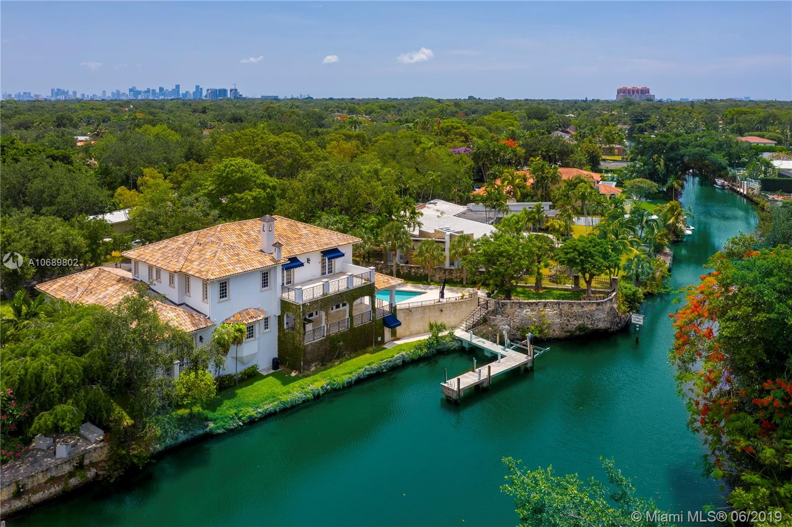This 6,542 SF gated home is situated on a wide section of the waterway that leads to Biscayne Bay. The custom designed 5 bed/5.5 bath home features a gourmet eat-in kitchen with top-of-the-line appliances, family room with a fireplace, wine cellar, heated pool and spa, a gorgeous covered patio, and 2 boat lifts on a dock that can hold 3 boats.