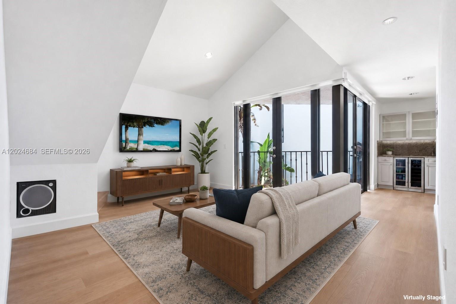 Lucky number 777. This unit features a rare LOFT plus soaring vaulted ceilings (17 ft. living & 13 ft. bedroom) — creating a second flexible living space that's difficult to find in 777 square feet. Ideal for home office, media space, studio, or the functionality of a 2nd bedroom. Only 3 of the 13 units in this boutique gated community have the LOFT and vaulted-ceiling combo. Square footage per appraiser (larger than tax roll), and between the ceiling height and natural light, it lives far bigger than the number suggests. Thoughtfully updated with high-end finishes: new neutral-tone floors, custom staircase, Elfa closets, motorized shades. The kitchen delivers granite counters, new stainless steel appliances, under-cabinet LED lighting, and bar area with a dual-zone wine & beverage fridge. The travertine marble bath features a fully enclosed shower with 8 adjustable heads (4 ceiling & 4 body sprays), new quartz-top vanity, and front-lit mirror/medicine cabinet. In-unit front-load washer & dryer. 1 assigned covered parking space, plus guest spaces for a 2nd vehicle. Quiet gated community with a POOL. Unbeatable location EAST of US-1, in one of Miami's most walkable neighborhoods. 4 blocks to CocoWalk's restaurants & bars, with the Grove's best dining at your feet, plus Milam's, Home Depot, Bodega Ortega, and Flanigan's nearby for the everyday. Minutes to Coral Gables, I-95, & Brickell/Downtown. 50-Year Recertification completed in 2023. NO special assessments. Low HOA fees.