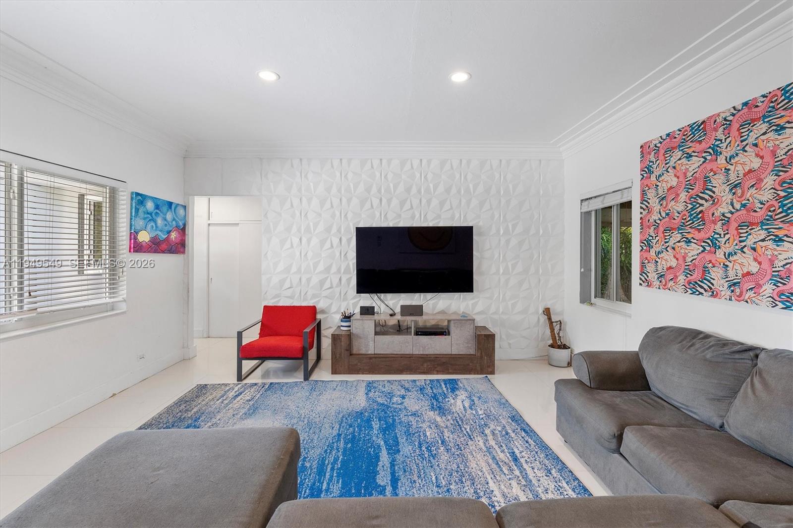 An exceptional opportunity to own a true waterfront gem in North Miami, where comfort, flexibility, and future upside converge. This beautifully updated 3-bedroom, 2-bath residence is positioned on an oversized lot along the Biscayne Canal, offering approximately 1,950 square feet of thoughtfully designed living space plus a rare 700 square foot detached garage/studio located directly on the water—ideal for a home office, gym, guest suite, creative studio, or additional entertaining space. The open and inviting kitchen is designed for both everyday living and hosting, featuring granite countertops, stainless steel appliances, generous cabinetry, and seamless flow into the main living areas. White tile floors and impact windows throughout enhance the bright, airy feel while providing peace of mind. A spacious primary suite anchors the desirable split-bedroom layout, offering privacy and comfort. The large screened porch overlooks lush native landscaping and mature fruit trees, creating a tranquil outdoor setting perfect for morning coffee or evening gatherings. Natural gas line in place. Enjoy serene canal-front living today, with the added long-term value of planned direct access to Biscayne Bay by 2030—an exciting opportunity for boating enthusiasts and future-minded buyers alike.