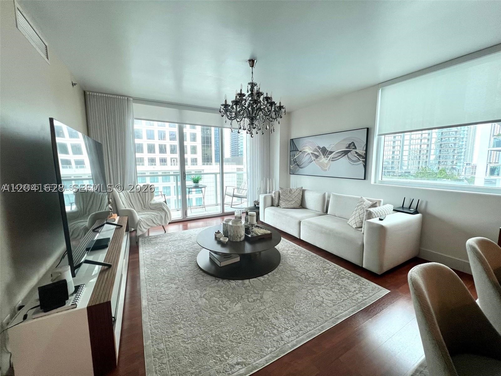 Luxury living or premium investment opportunity at the prestigious 500 Brickell Condominium! This exquisite and spacious 2BR/2BA unit spans 1,200 sq ft, offering stunning urban views from its private balcony. Impeccably designed, the residence features a modern kitchen with stainless steel appliances, spacious walk-in closets, in-unit washer/dryer, and high-end tech upgrades including smart lighting and remote-controlled shades. Includes 1 assigned covered parking space on the 3rd floor. Residents enjoy world-class amenities: two pools (including a rooftop deck), a state-of-the-art gym, theater, spa, club room, 24-hour concierge, and valet. Unbeatable location within walking distance to Brickell City Center, world-class dining, and cafes, and just 10-15 minutes from Miami Beach. Perfect to move in or capitalize on Miami's hottest market. Information is deemed reliable but not guaranteed and should be independently verified by buyer's agent.