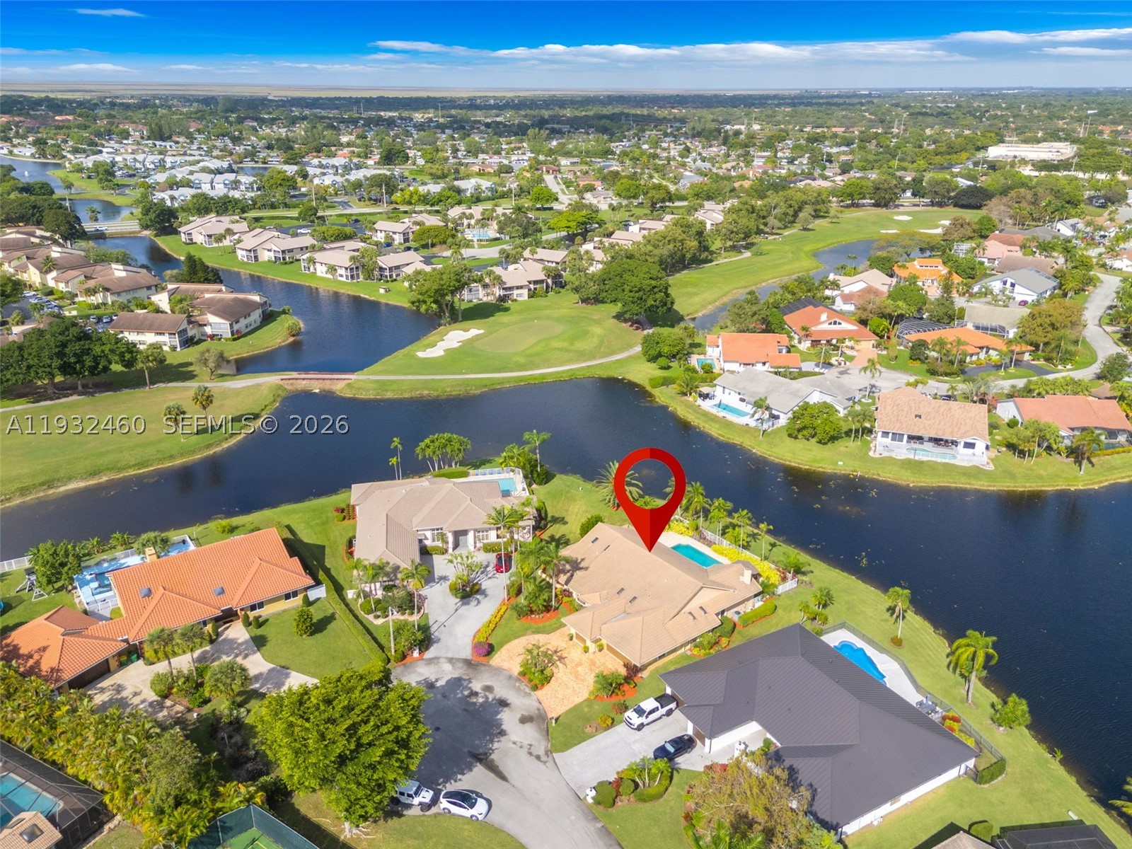Nearly ½-Acre Waterfront Estate on a Premier Cul-de-Sac Lot
Rare opportunity to own one of Woodmont's largest and most desirable waterfront homesites. Situated on an expansive 17,735-square-foot cul-de-sac lot with panoramic water views, this custom single-story residence offers 3,702 square feet under air, exceptional privacy, and generous room sizes throughout.
The flexible floor plan features 3 bedrooms plus a dedicated media/theater room, soaring volume ceilings, spacious living and family rooms, a luxurious primary suite with sitting area, and an oversized 2-car garage with separate golf cart garage.
Outdoor living shines with an expansive paver patio, resort-style pool, mature tropical landscaping, and long water views that create a true private retreat. The nearly half-acre setting provides a rare sense of openness and separation from neighboring homes.
Additional features include a backup generator servicing much of the home, accordion shutters, custom wood cabinetry, double ovens, and premium finishes throughout.
An exceptional opportunity to personalize a home with outstanding space, privacy, and one of the most unique waterfront lots in Woodmont.
