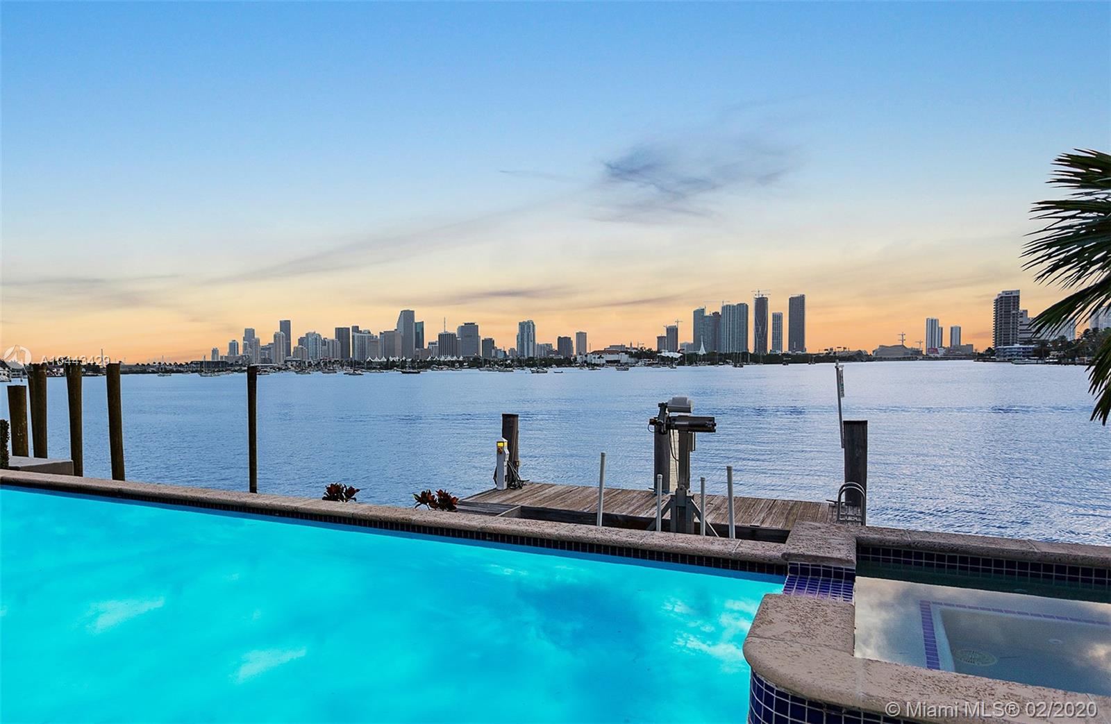 Location, location, location! Live on the wide-open water with the most coveted view in all of Miami. Enjoy sweeping views of the downtown Miami skyline & the most dramatic sunsets from this new Italian style waterfront villa. Enter the home through a charming courtyard & beautiful foyer. Boasting 5 bedrooms, 5 bathrooms & 2 half baths this 6,788 square foot residence sits on a 9,953 square foot lot. Features include: boat dock/lift, 2 garages, a guest house with separate entrance, formal dining room, family room with double height ceilings, custom woodwork throughout, a gourmet kitchen with Sub-Zero & Wolf appliances, marble & wood floors, an expansive master suite with a kitchenette, his/hers walk in closets, a spa-like master bathroom & an expansive balcony offering panoramic views.
