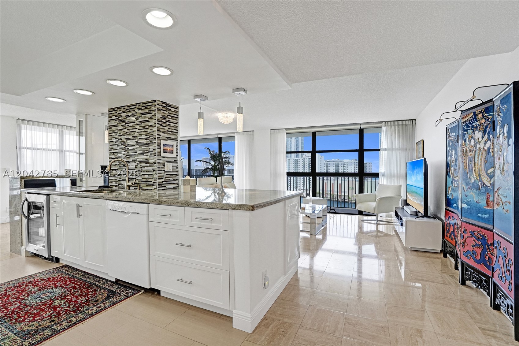 This beautifully renovated 1,430 sq. ft. residence features an expansive open-concept floor plan designed for both comfortable living and effortless entertaining. The stunning chef’s kitchen boasts granite countertops, an oversized breakfast bar, abundant cabinetry, designer lighting, and a new Bosch dishwasher—all perfectly positioned to enjoy the spectacular water views.
Floor-to-ceiling windows fill the home with natural light while showcasing endless northeast vistas. The spacious primary suite features an oversized walk-in closet and incredible ocean and Intracoastal views. The spa-inspired primary bathroom offers both a luxurious soaking tub and a separate walk-in shower. A beautifully updated guest bath, in-unit washer and dryer, and generous storage add everyday convenience.
Step outside to the oversized wraparound balcony—the perfect place to enjoy your morning coffee, entertain guests, or relax while watching boats cruise by and the sun rise over the ocean.
Additional highlights include two covered parking spaces, an extra storage unit, and select furnishings available for purchase.
Oceanview residents enjoy resort-style amenities and an unbeatable location just minutes from the beach, shopping, dining, Gulfstream Park, Aventura Mall, and major highways.
Minimum rental period of two years.
