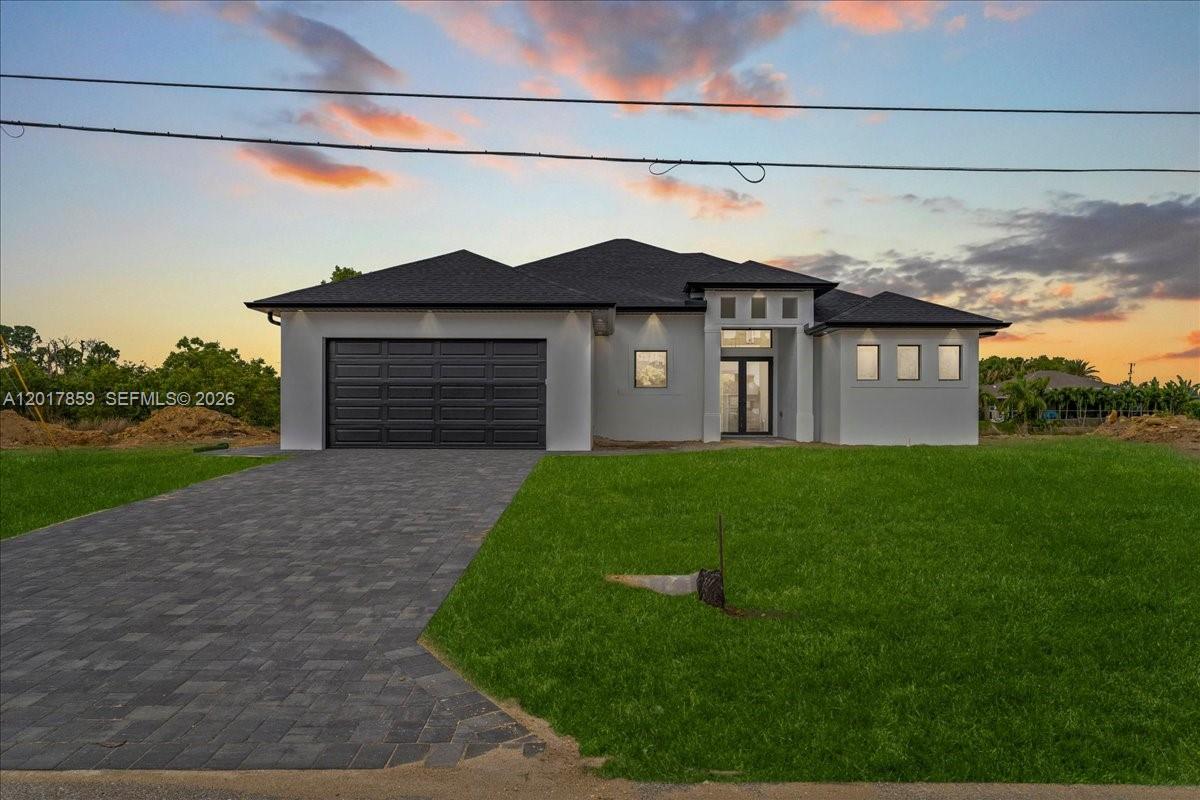 Emma Model | New Construction Pool Home in Cape Coral. Located in one of the fastest-growing areas of Cape Coral, this newly constructed 4-bedroom, 3-bathroom pool home offers 2,073 sq ft under air with a functional split floor plan designed for modern Southwest Florida living. The open-concept layout seamlessly connects the kitchen, dining, and living areas, creating a bright and inviting atmosphere ideal for both everyday living and entertaining. The centrally positioned kitchen features generous counter space and overlooks the main living area and covered lanai. The private primary suite includes dual vanities, a walk-in shower, and a spacious custom walk-in closet. One guest bedroom offers direct access to a full bathroom, providing an ideal setup for guests or multi-generational living, while two additional bedrooms and a third full bath offer flexibility for a home office, gym, or growing household. Step outside to enjoy the Florida lifestyle with a covered lanai and private pool designed for year-round enjoyment. Additional features include oversized porcelain tile flooring, impact windows and doors, modern finishes, dedicated interior laundry room, and a 2-car garage. Not located in a flood zone and no outstanding assessments. City water and sewer are in place, features many buyers prioritize when purchasing in Cape Coral. Move-in ready and thoughtfully designed to maximize comfort, functionality, and style.