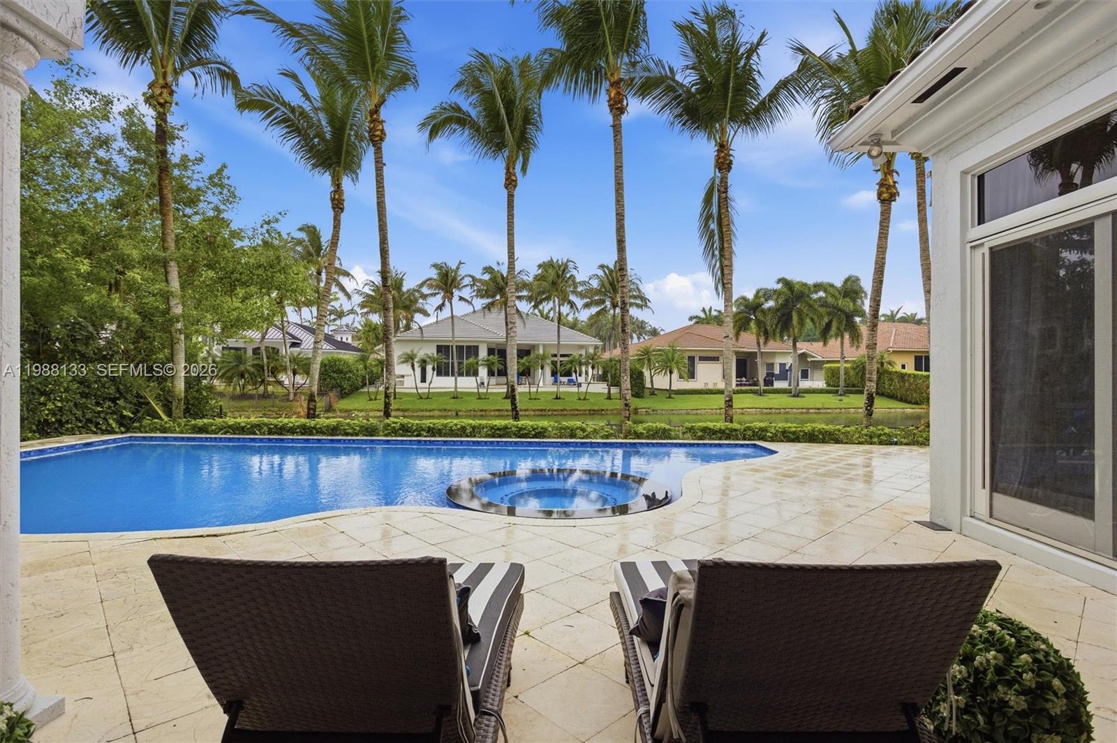 Where exclusivity meets effortless luxury—welcome to Hawks Landing, one of Plantation’s most coveted private enclaves. This exceptional residence on highly sought after Sweet Bay Ave offers a spectacular waterfront estate with five bedrooms, office and 3 car garage. The first level features: your primary suite with waterfront views and two walk in closets, an office, en-suite bedroom, updated chefs kitchen with breathtaking marble countertop and backsplash, stainless steel Thermodore appliances and gas stove, family room and full cabana bath. Second level features: loft with three en-suite bedrooms and a beautiful balcony. A personal paradise with oversized patio area perfect for entertaining with updated pool and spa, wide water views, awning covering your built in grill, mounted TV and mini fridge. A lifestyle defined by elegance, privacy, and world-class amenities, all within a 24-hour guard-gated and patrolled community. Indulge in resort-style living with access to your private clubhouse, state-of-the-art fitness center, tennis, basketball and pickleball courts, a vast community pool and monthly events to meet neighbors and network. This home provides seamless access to everything South Florida has to offer while maintaining a serene, private setting. Surrounded by lush landscaping and distinguished estates, Hawks Landing represents luxury living, exclusivity and charm.