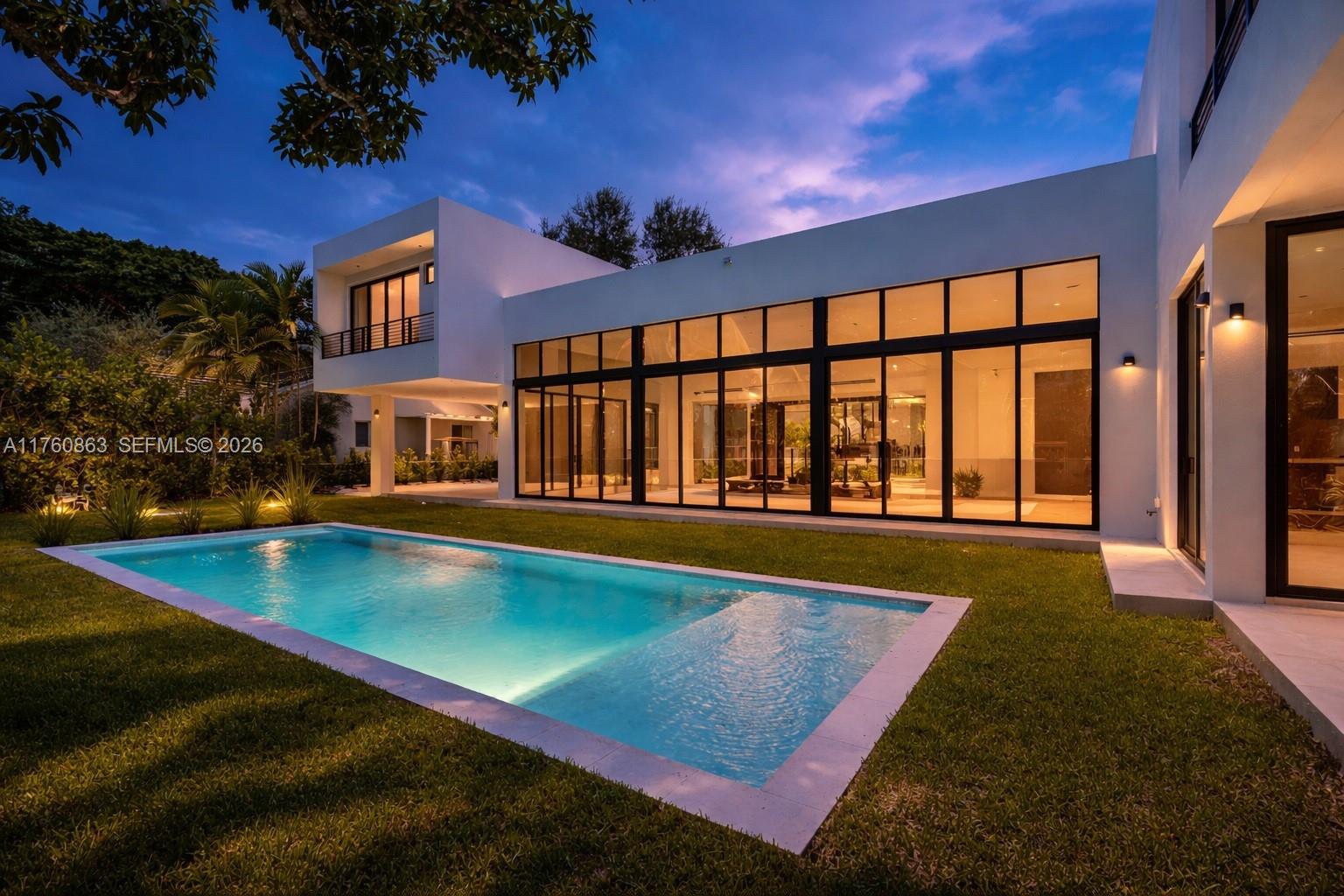 Step into this stunning residence on an oversized lot where elegance meets modern design. A grand entrance with solid core doors leads to Pedini cabinetry, porcelain countertops, and a chef’s kitchen with Miele appliances. The spacious great room features high ceilings and large impact-resistant doors and windows, flooding the home with natural light and showcasing the outdoor retreat with two covered terraces and pool. Upstairs offers three en-suite bedrooms, a secondary laundry, and a luxurious primary suite with private terrace, oversized closet, and spa-like bath. Closets and vanities by Pedini Miami. Elevator-ready and future-ready for a smart home system. Move-in ready with CO in hand.