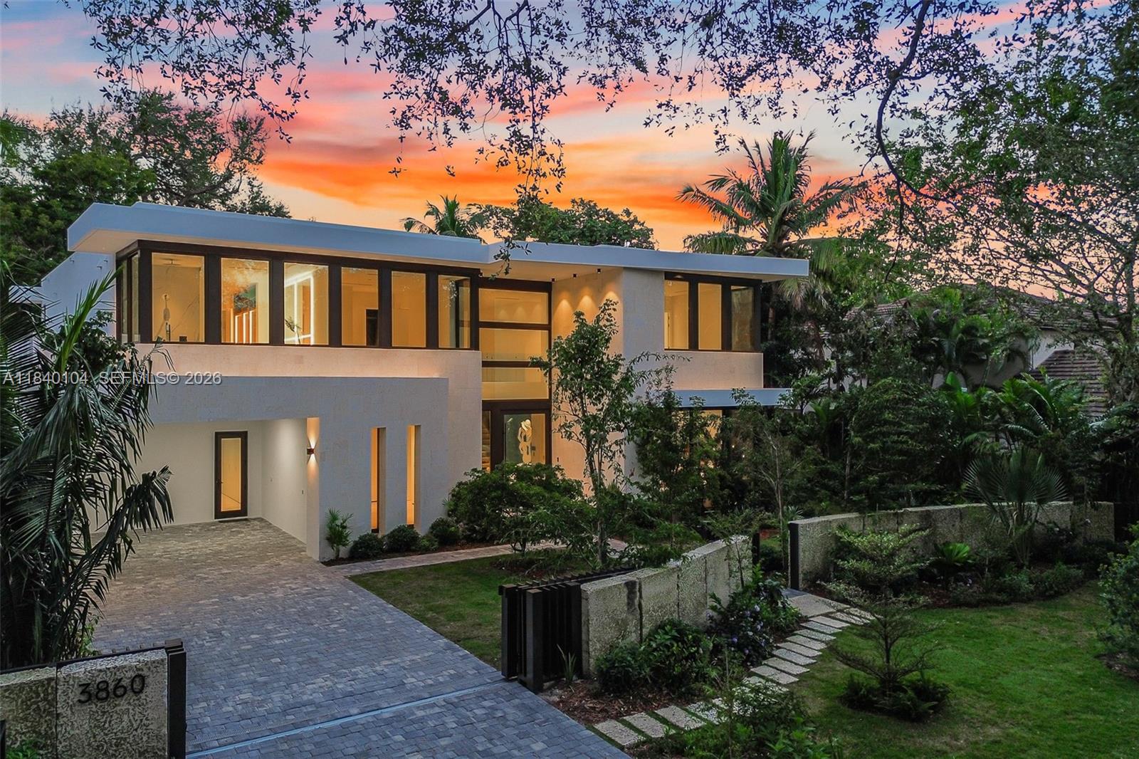 Nestled within the exclusive, gated community of Ye Little Wood. This architectural showpiece redefines modern luxury living. Offering 7 bedrooms, 7 full and 2 half baths across 7,277 SF, the home features floor-to-ceiling glass, clean lines, and a radiant connection to lush tropical surroundings. Designed for elevated living and effortless entertaining, enjoy a resort-style pool, full summer kitchen, and expansive indoor-outdoor spaces. The primary suite is a serene sanctuary of understated luxury, thoughtfully designed with refined finishes, natural light, and a calming ambiance. Minutes from Coconut Grove’s vibrant shops and dining, top-rated schools, and world-class marinas. Broker has ownership interest in the property. Built by Insignia Construction Company.