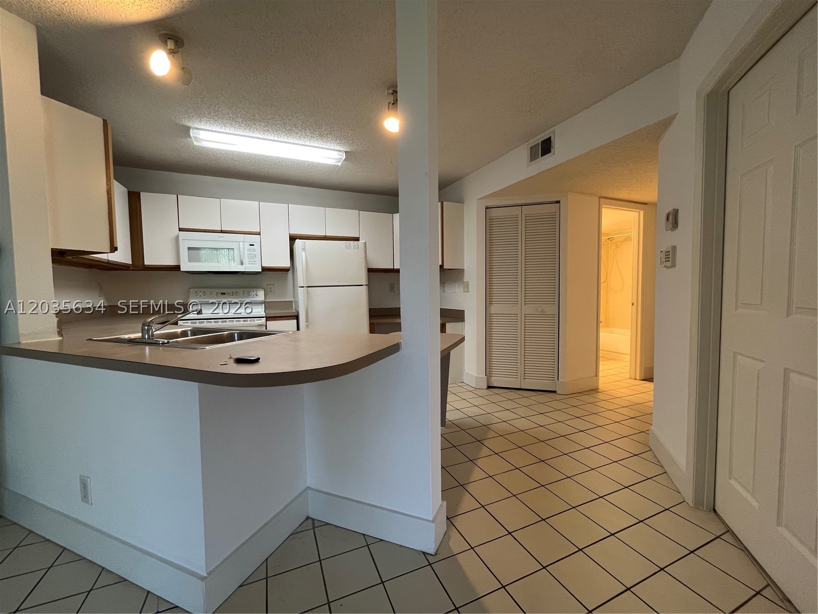 Spacious 3-bedroom, 2-bath condo with a one-car garage located in the desirable Windward Lakes community. This well-maintained unit features tile and laminate flooring throughout, a walk-in closet, and an in-unit washer and dryer for added convenience. Rent includes water, sewer, and trash services. One pet is welcome (maximum 40 lbs) with a $250 non-refundable pet fee. Residents enjoy access to community amenities, including a pool and fitness center. Conveniently situated near major roads, I-95, shopping, dining, and just minutes from the beach. Move-in requirements include first month's rent, last month's rent, and one month's security deposit. Association approval process typically takes 2 to 4 weeks.
